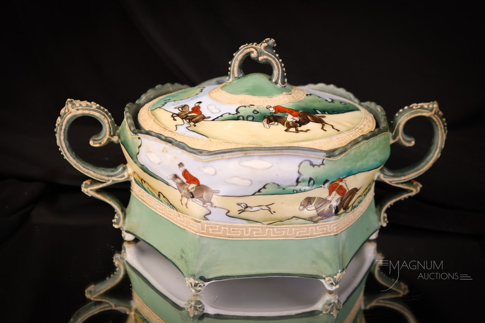 Blue Mark Nippon Moriage "Hunt Scene" Cracker Jar: A seldom found and nice piece of blue mark Nippon porcelain. This is a cracker jar with double handles. It is decorated with a hunt scene. It has Moriage embellishments. The cracker jar measures 5 1/4