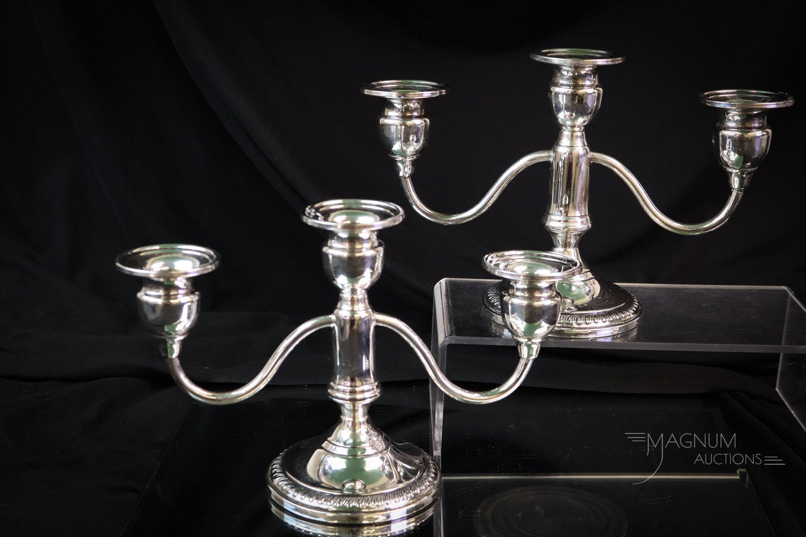 Pair of Weighted Sterling Silver Candlabrum 20.038 OZT: A fine pair of weighted sterling silver candleabrum. The weight of the pair is 20.038 OZT. Each measures 5 3/4" tall and 8 1/2" wide. SHIPPING NOTICE: If you choose not to utilize the LiveAuctioneers 