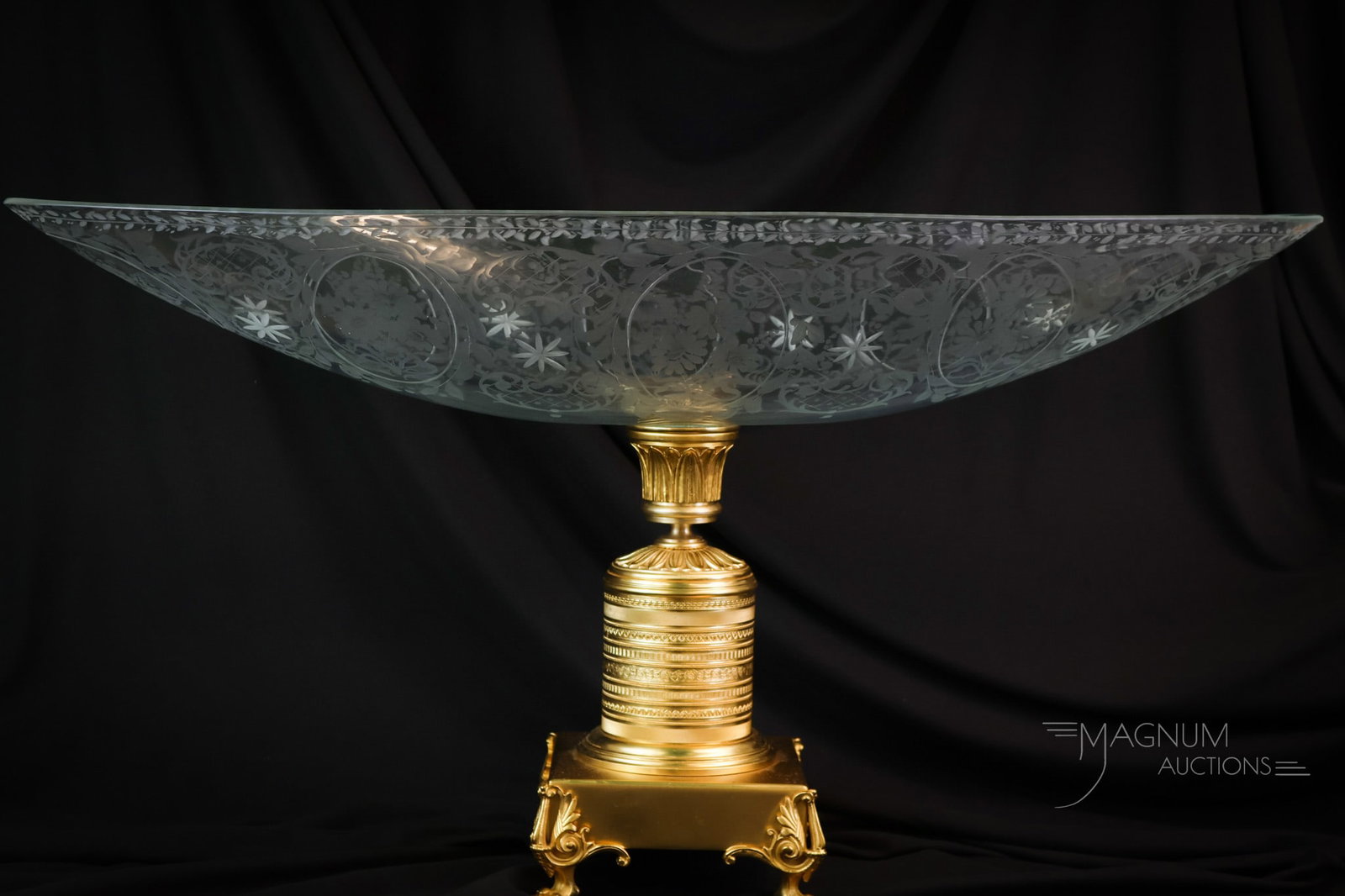 Monumental 31" Vetrerie di Empoli Gilt Bronze & Glass Centerpiece: A monumental gilt bronze and glass centerpiece. This piece measures 15 1/2" tall and 31" wide. It is an Empire-style, aristocratic glass oval fruit bowl on a bronze base. The piece is by Vetrerie di E