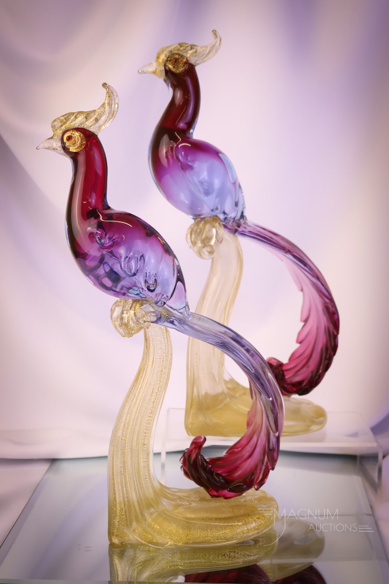 Pair Italian Murano Glass "Birds of Paradise" Sculptures: A gorgeous pair of Italian Murano glass "Birds of Paradise" sculptures. Each of these colorful birds measures 15 3/4" tall and 8" wide. The glass has inclusions of lavender-blue and gold flecks. SHIPP