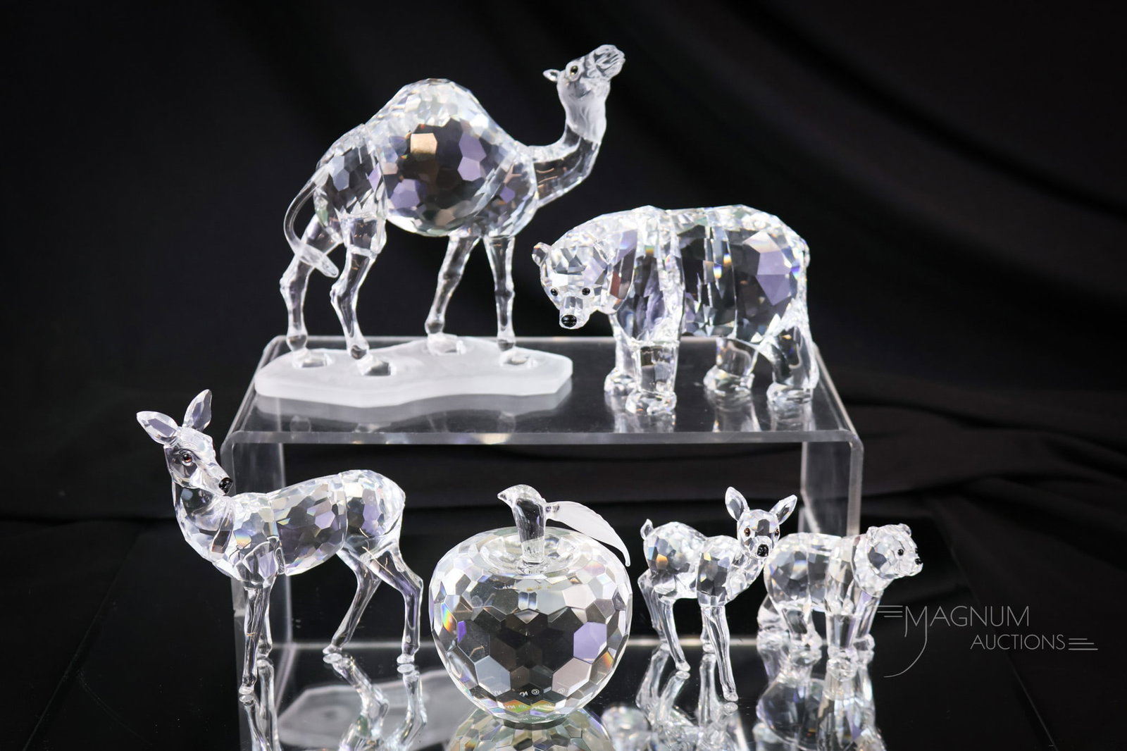 6 pc Lot Swarovski & More Crystal Figurines Sculptures: A generous assortment of six Swarovski and more crystal animal figurines. The apple is marked NYC Apple. The tallest measures 4 1/2". SHIPPING NOTICE: If you choose not to utilize the LiveAuctioneers 