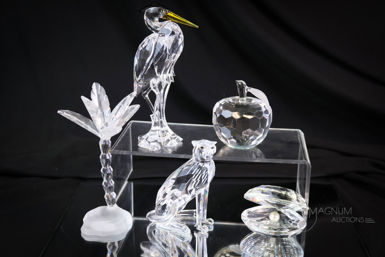 5 pc Lot Swarovski & More Crystal Figurine Sculptures: This generous lot of Swarovski crystal figurines is sure to please. There are four marked Swarovski. The apple is marked NYC apple. The tallest measures 6". SHIPPING NOTICE: If you choose not to utili