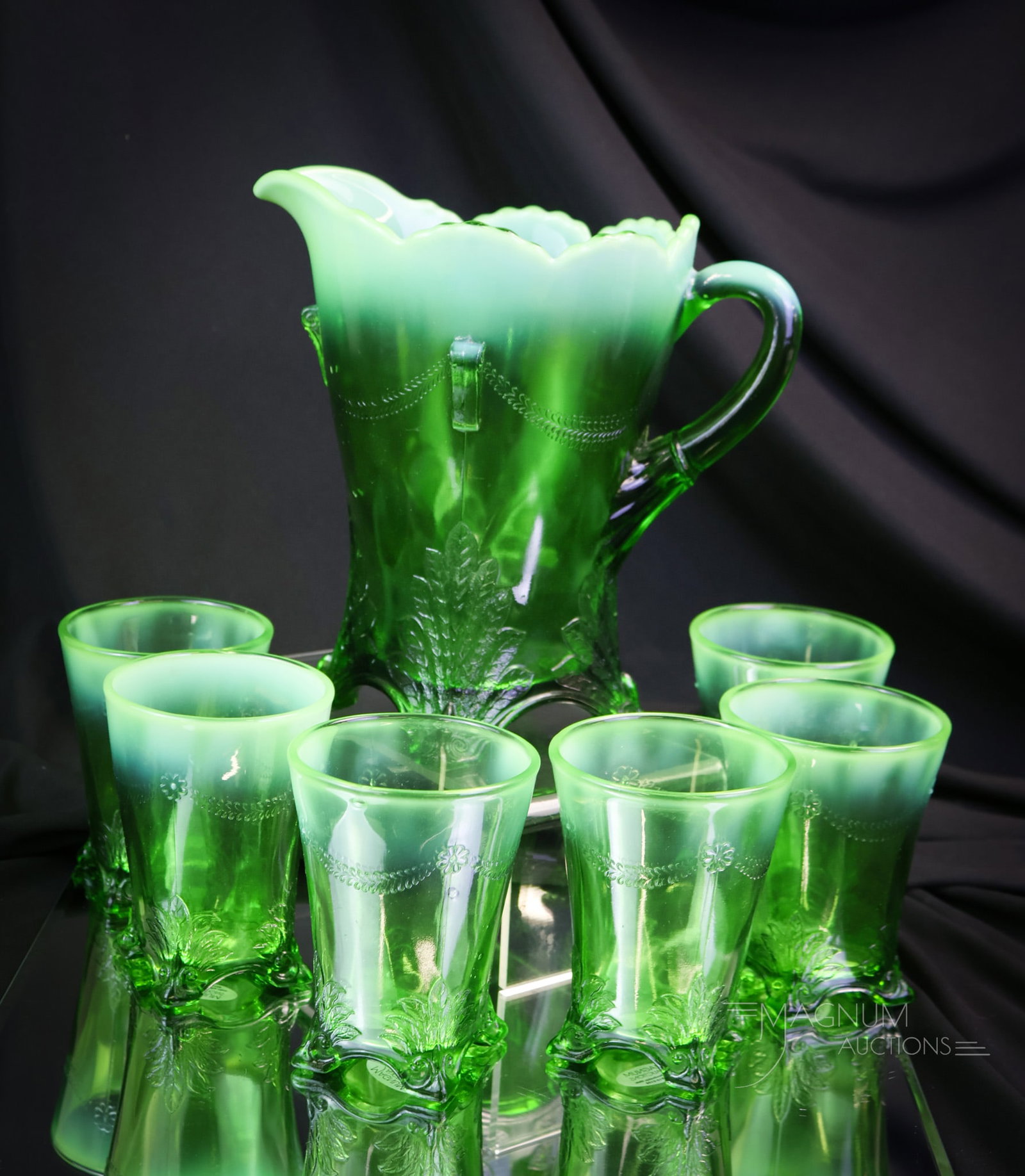 7 pc Jefferson Swag with Brackets Green Opalescent Victorian Water Set: A striking and complete water set in the Jefferson Swag with Brackets pattern. This set includes a pitcher and six tumblers. Each piece has great coloring. The pitcher measures 8" tall. There is a sma