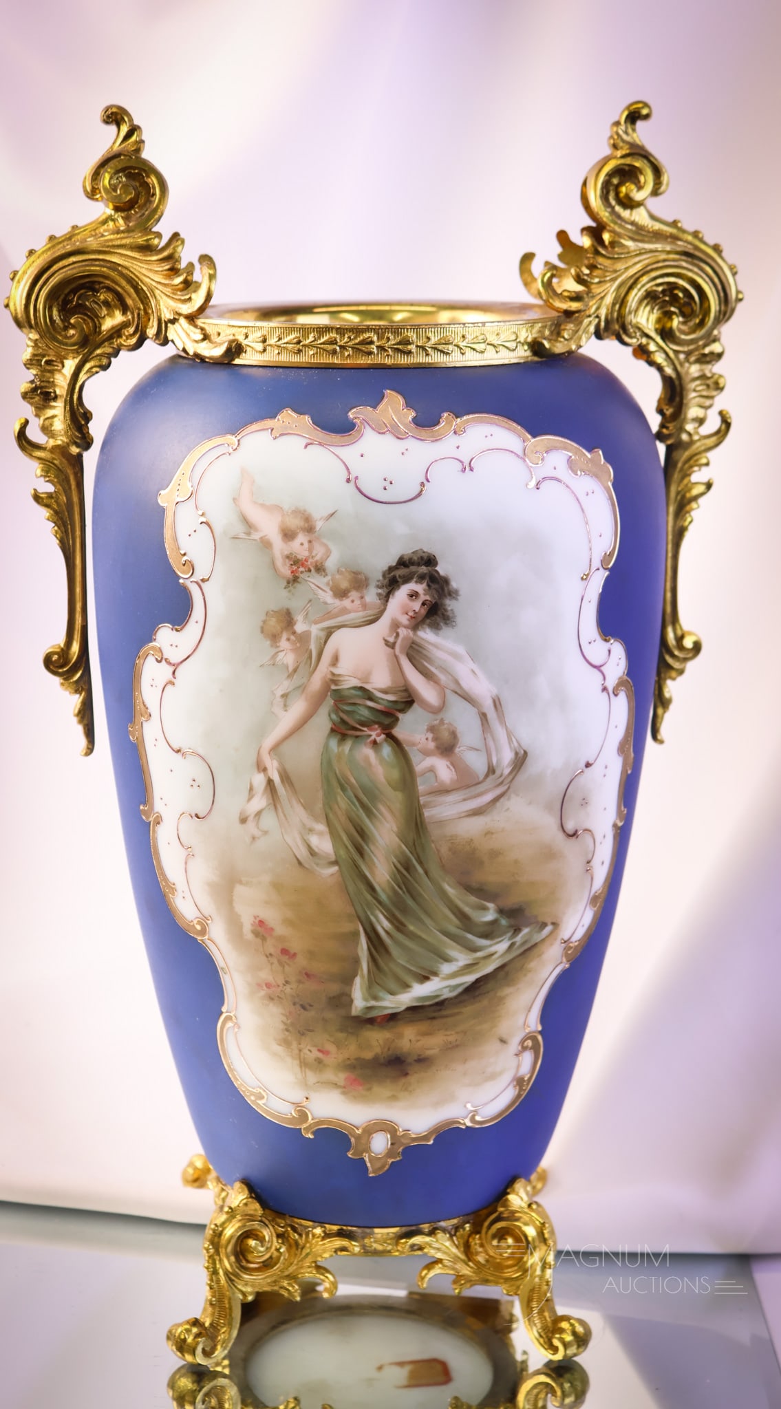 Monumental Wave Crest Ormolu Victorian Cobalt Glass Portrait Vase: A fantastic find in Victorian Wave Crest. This vase is a monumental 171/2" tall. It features cobalt coloring and a portrait of a woman withcherubs around her on the front and a scenic picture on the r