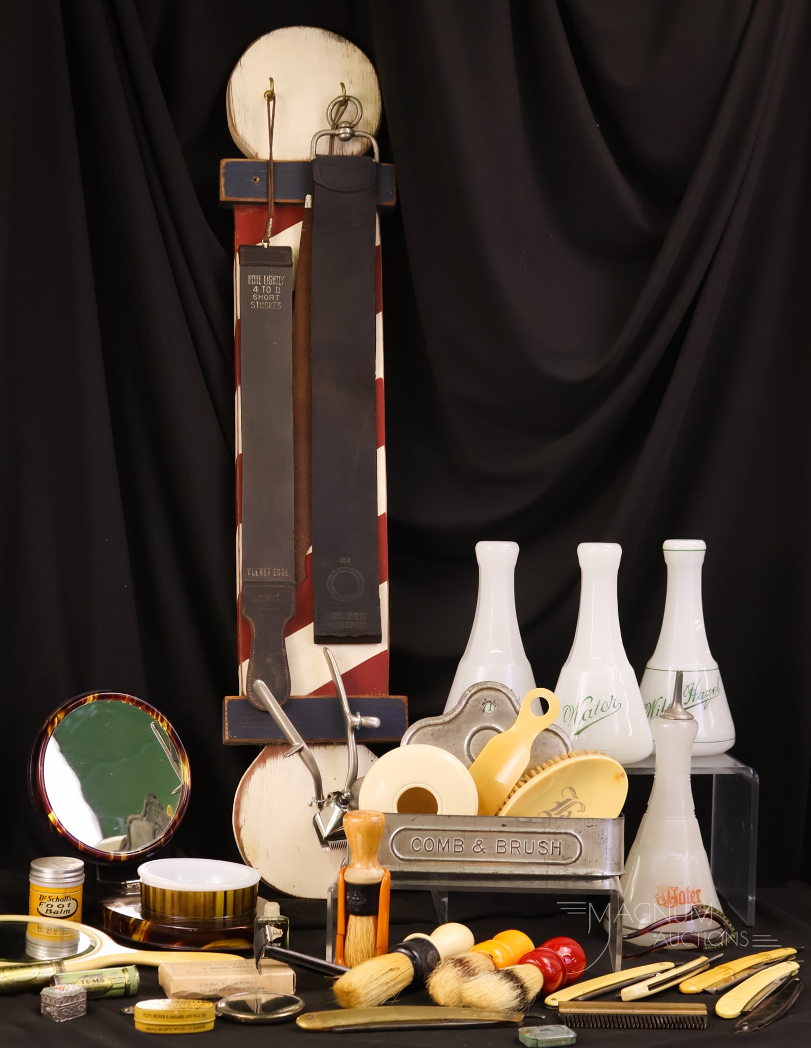 35 pc Lot Antique & More Barber Collecting Memorabilia: Thirty-five distinct finds in barber collecting items for your bidding pleasure. This lot includes 4 Moonstone barber bottles and a wooden barber pole hanger with two leather straps. There is two cell