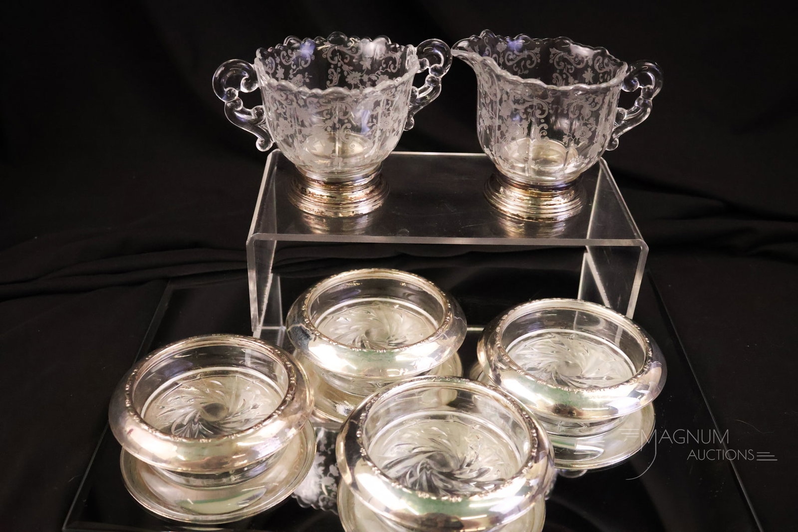 6 pc Lot Sterling Silver Trimmed Glass Articles: A six-piece lot of sterling silver-trimmed glass articles. The lot includes a Chantilly-etched creamer and sugar. The tallest is 3 1/2". The widest is 4 1/4".