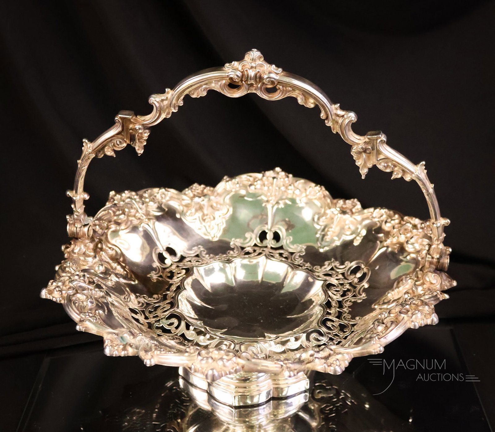 Antique Sterling Silver Basket 20.417 OZT: A beautiful handled basket with a scrolling design. The basket measures 9 1/2" tall and 10 1/2" wide. The piece weighs 20.417 OZT. WIRE TRANSFER OR CASH ONLY