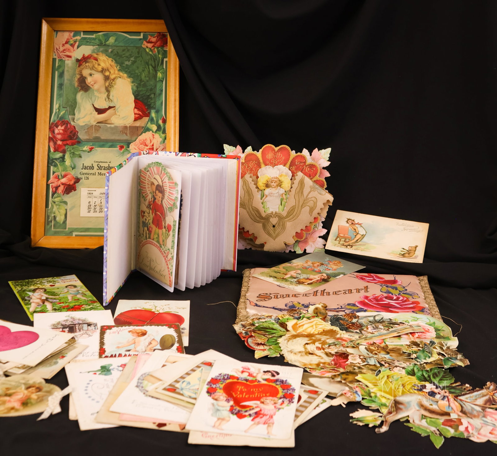 A Victorian & Vintage Valentine's Sweetheart Collectors Lot: A generous assortment of antique Valentine and Sweetheart collectible items. This lot offers 32 Valentine cards. There is also a bag of pop-up cards. A Jacob Strasburger framed calendar, and lastly,