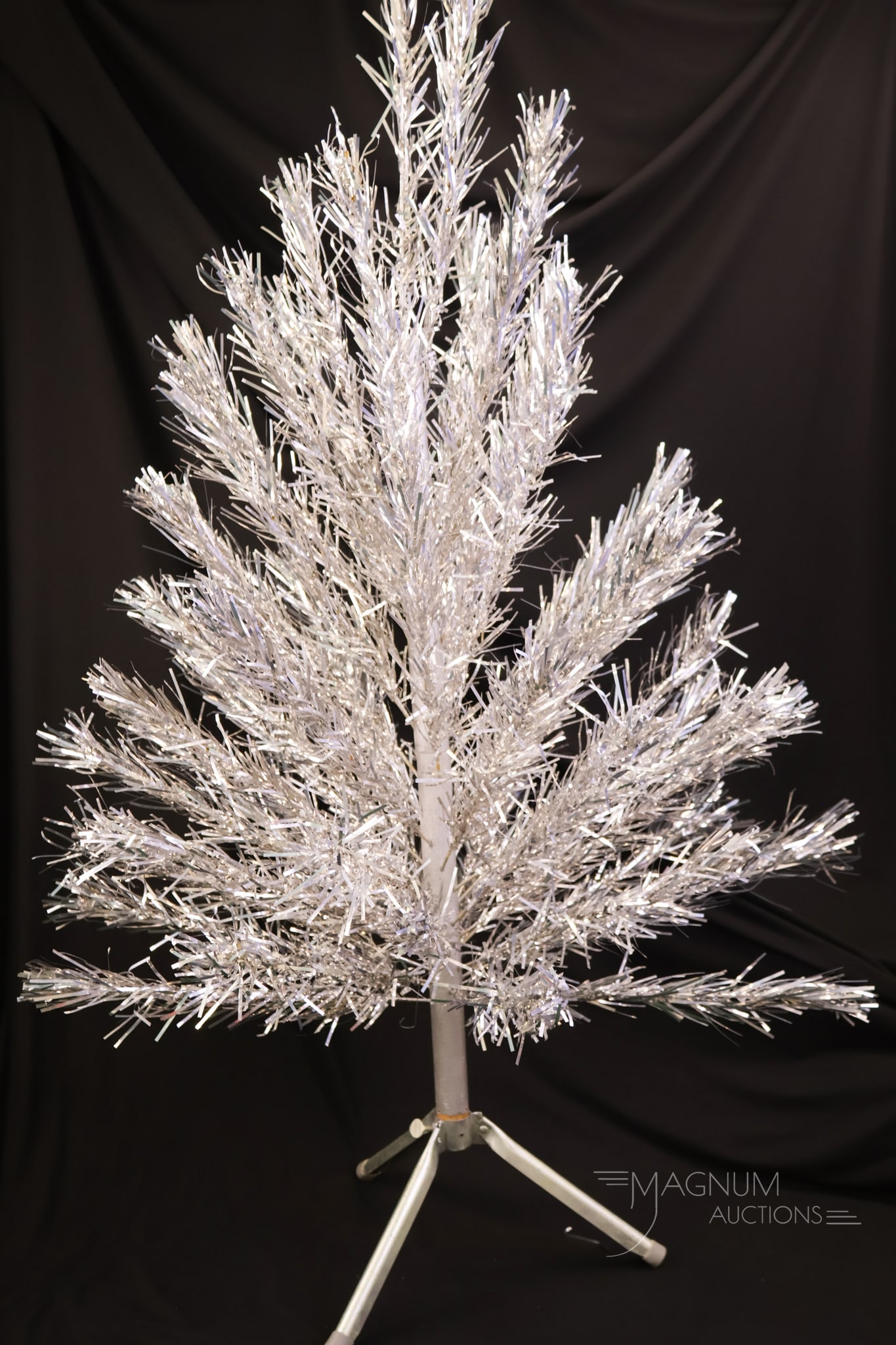 52" Vintage Aluminum Christmas Tree: A charming find in vintage Christmas decorations. This is an aluminum Christmas tree. This little guy measures only 52" tall and 29" wide.