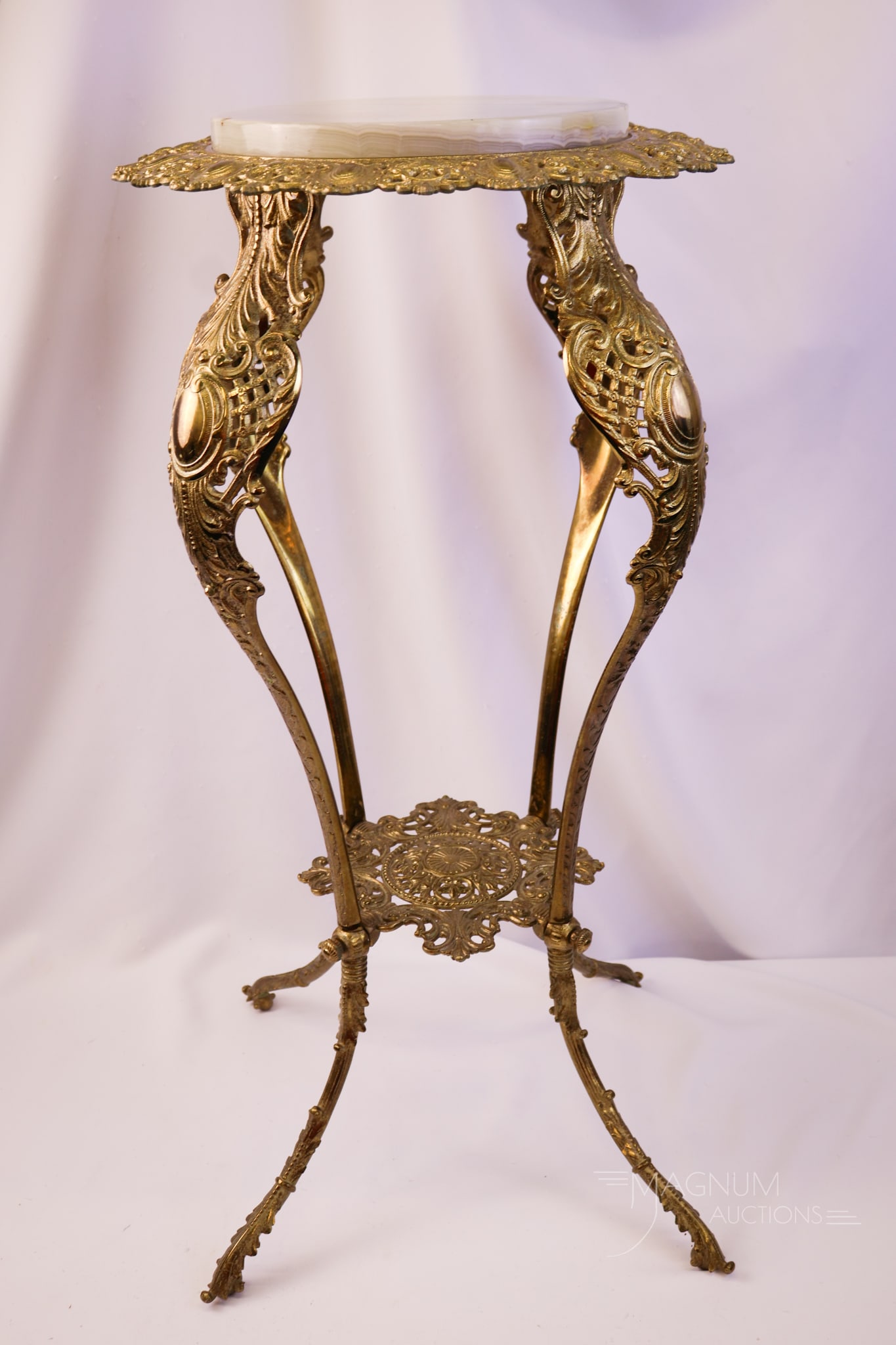 Antique Victorian Brass & Onyx Pedestal Fern Stand: Another lovely example of an antique brass and onyx Victorian Fern Stand. This piece features an ornate design and a beautiful onyx top. The stand measures 31" tall and 15" wide.