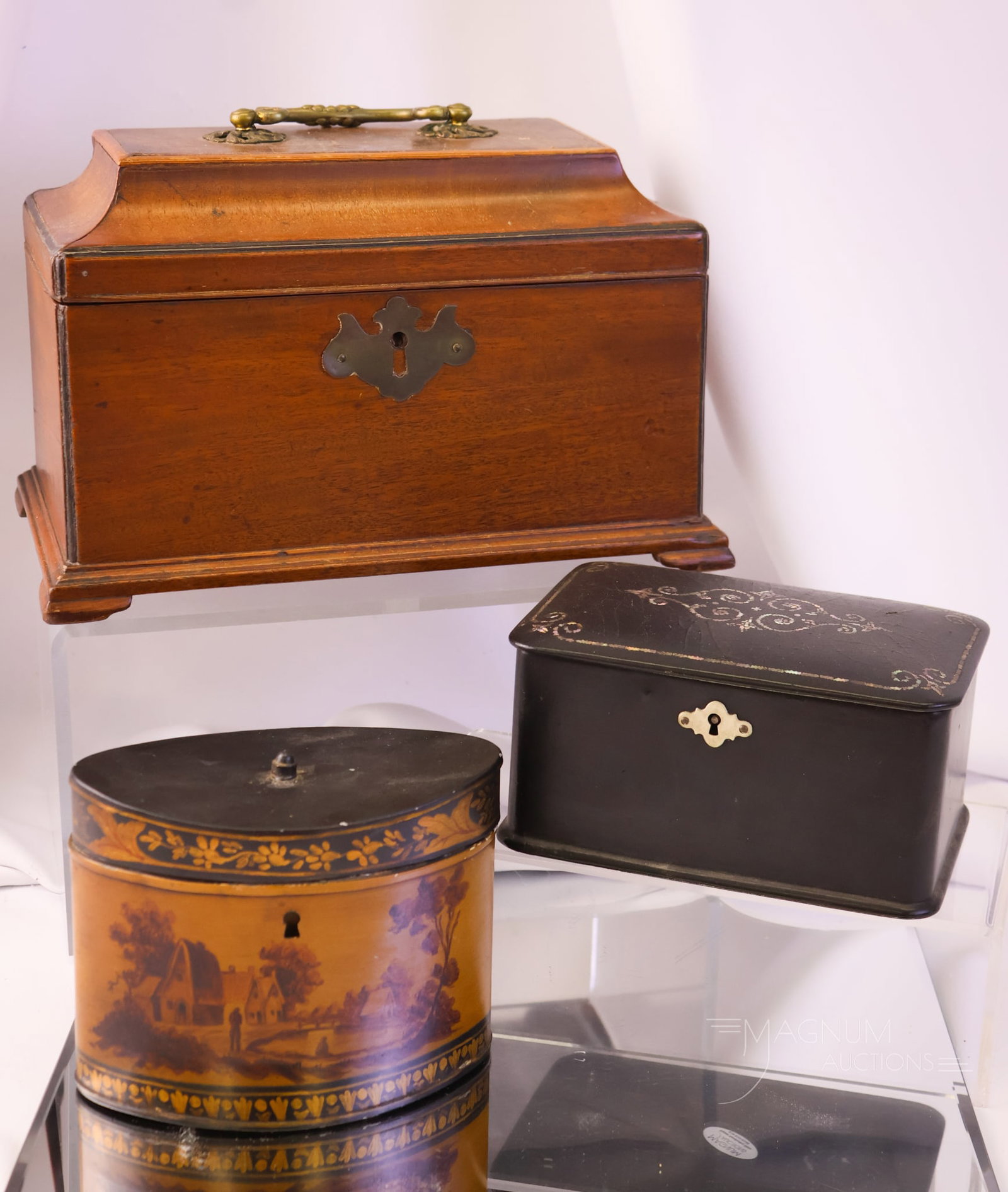 3 pc Lot Antique Tea Caddies: Three collectible antique tea caddies. The first is a mahogany wooden Georgian-style example. The second is a wooden example with leather inlay. This one has a loose lock mechanism. The third is a