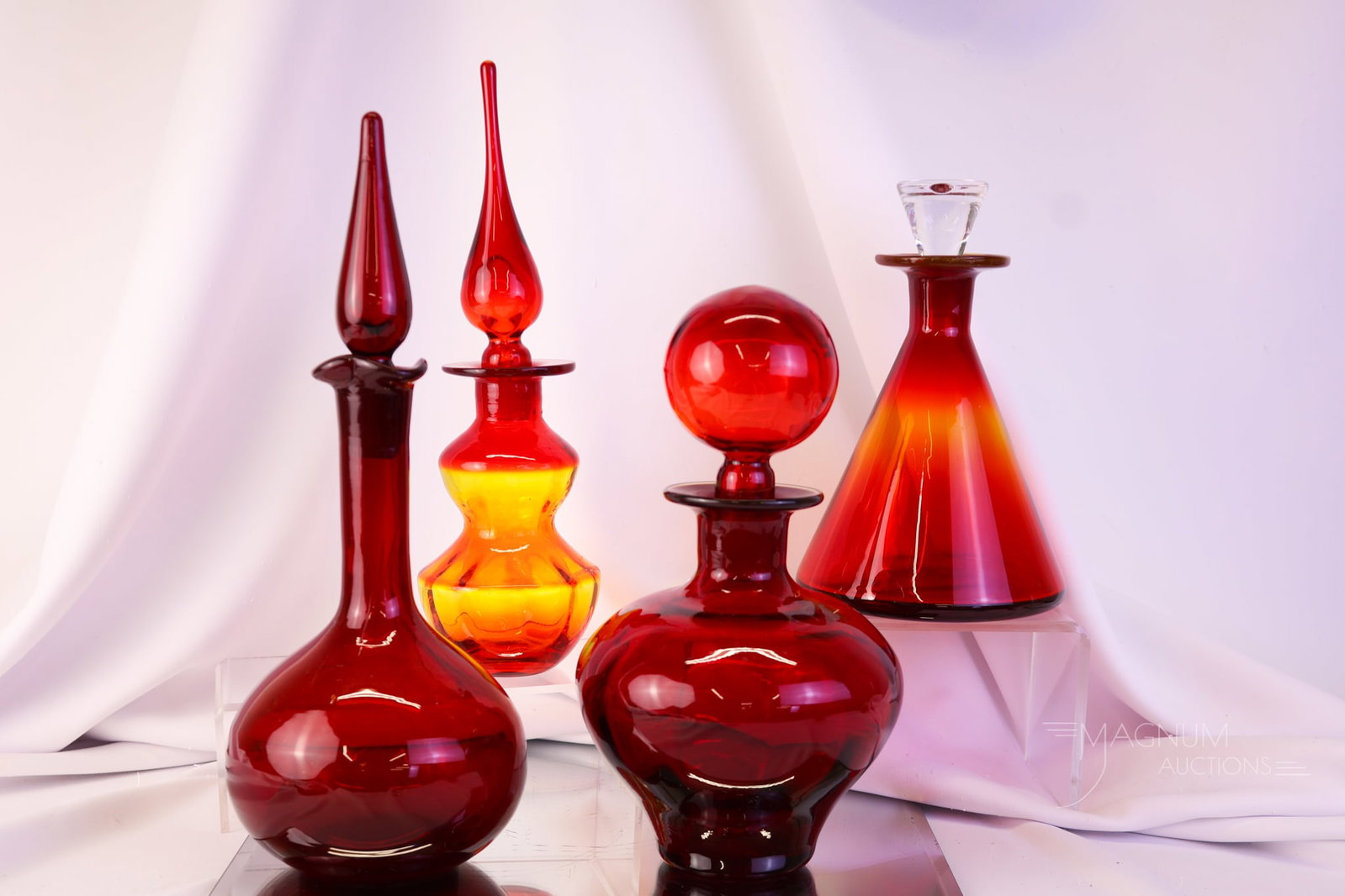 4 pc Lot MCM Art Glass Decanters Rainbow Blenko & More: Four distinct finds in MCM art glass decanters. The lot includes two Rainbow glass examples, one Blenko, and one unknown maker. The tallest measures 13 1/2".