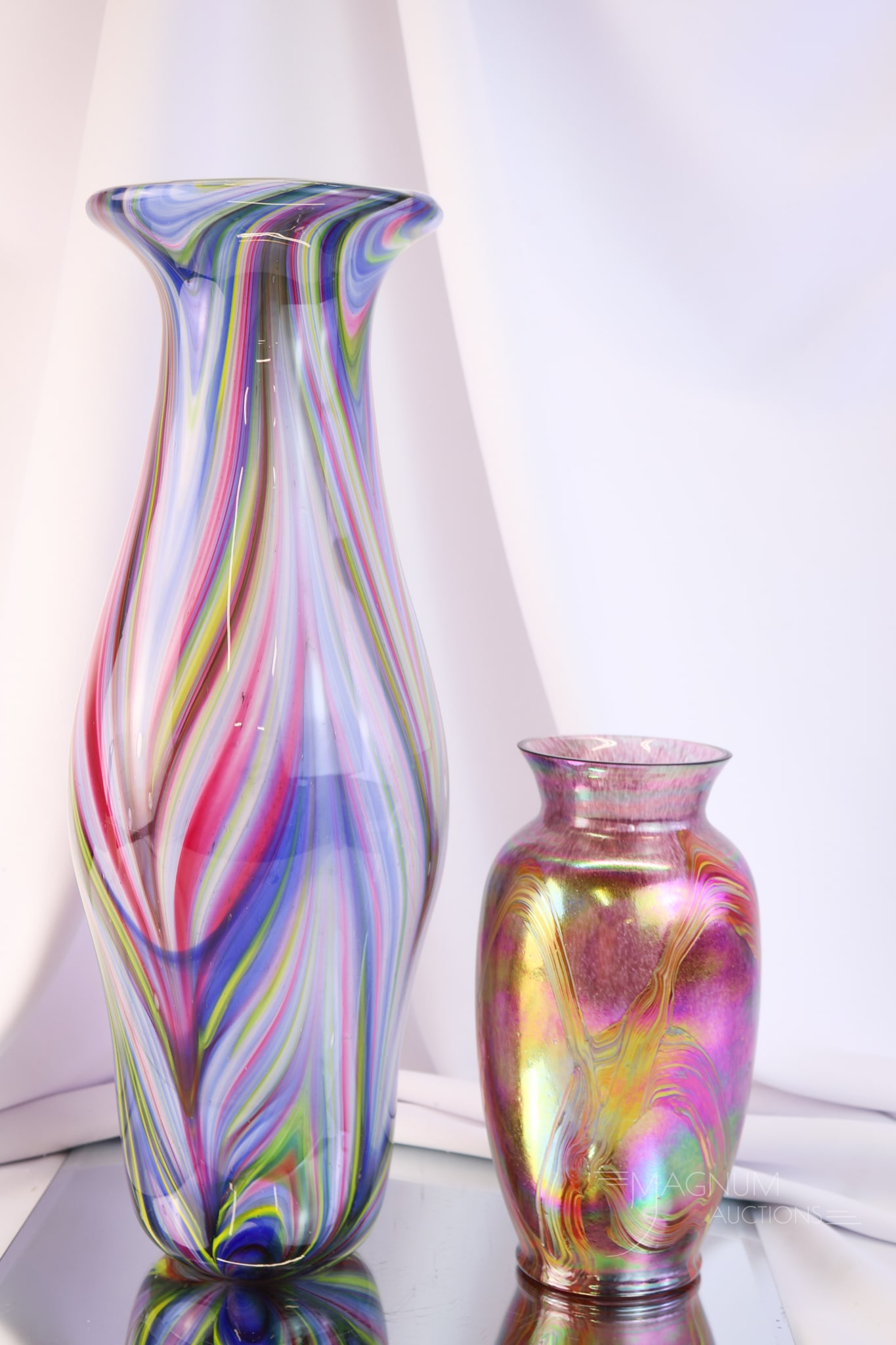 2 pc Lot Studio Art Glass Vases: Two desirable finds in attractive studio art glass. This lot offers a large 17 1/2" tall multi-colored vase with a feather pattern. This vase, along with another that has an iridescent finish and