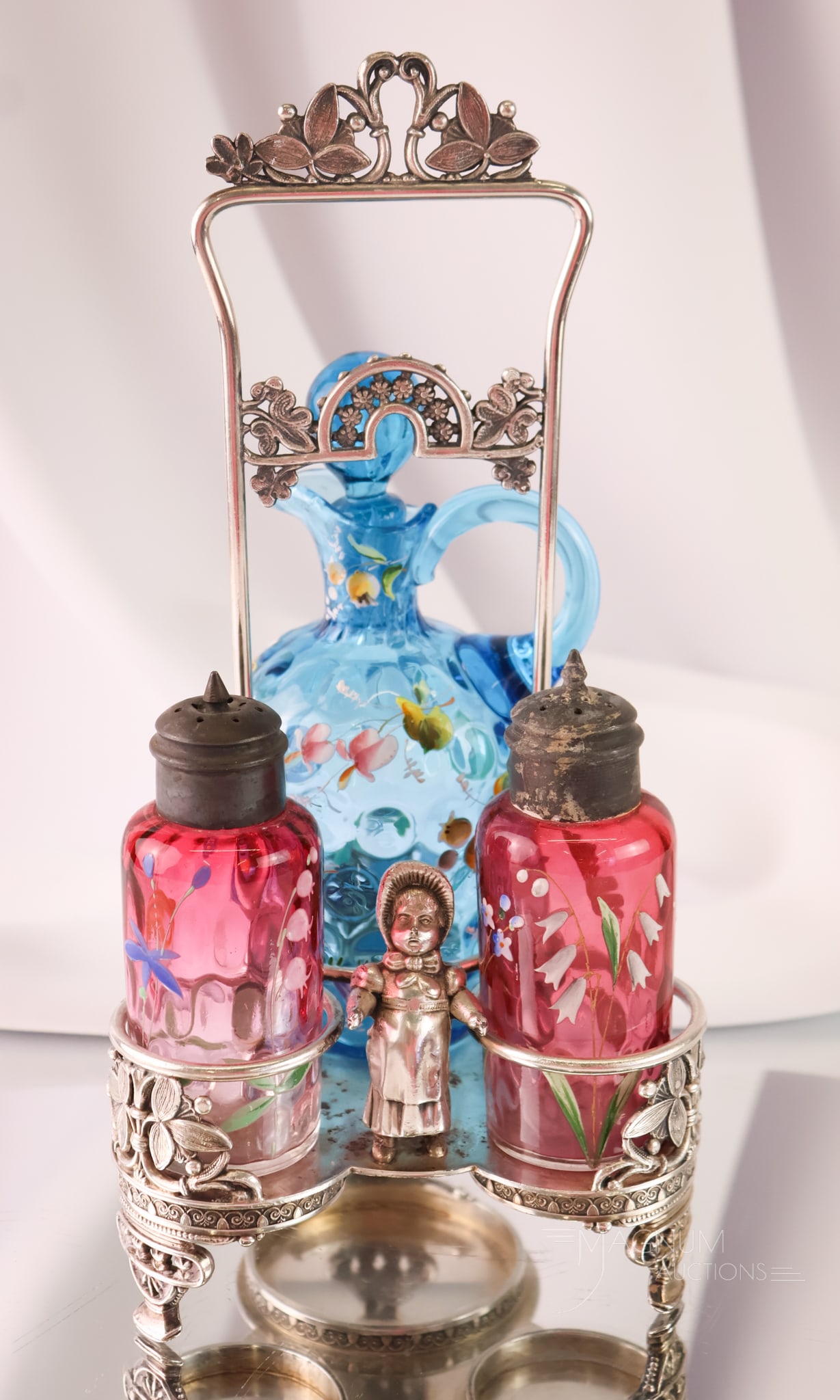Rockford Silverplate Kate Greenaway Victorian Glass Enamelled Cruet Shaker Condiment Set: A beautiful Victorian Kate Greenaway cruet condiment set. This set features a blue enameled glass cruet and cranberry-enameled shakers. The holder features a charming Victorian Kate Greenaway young