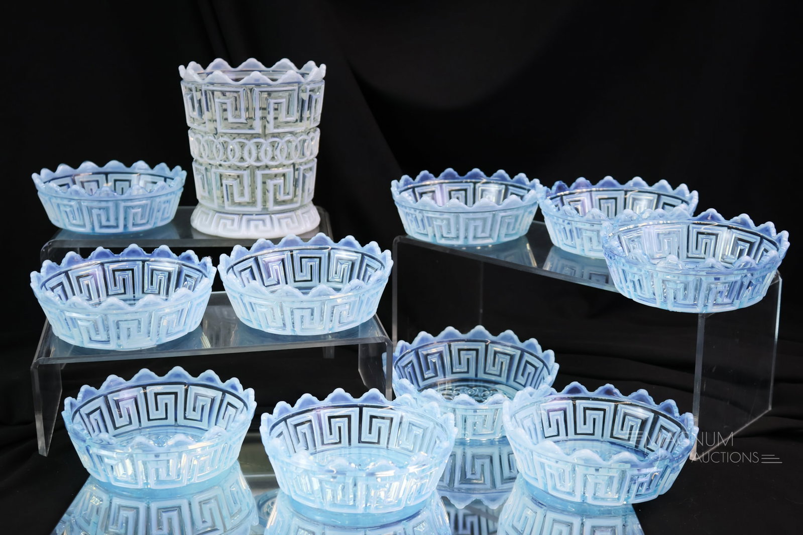 11 pc Lot Fostoria Nickel Plate Double Greek Key Victorian Opalescent Glass: Eleven collectible finds in Fostoria Nickel Plate opalescent glass. This lot includes a white opal sugar base along with ten blue opal berry bowls. The tallest of the lot measures 4 1/2". Five of the