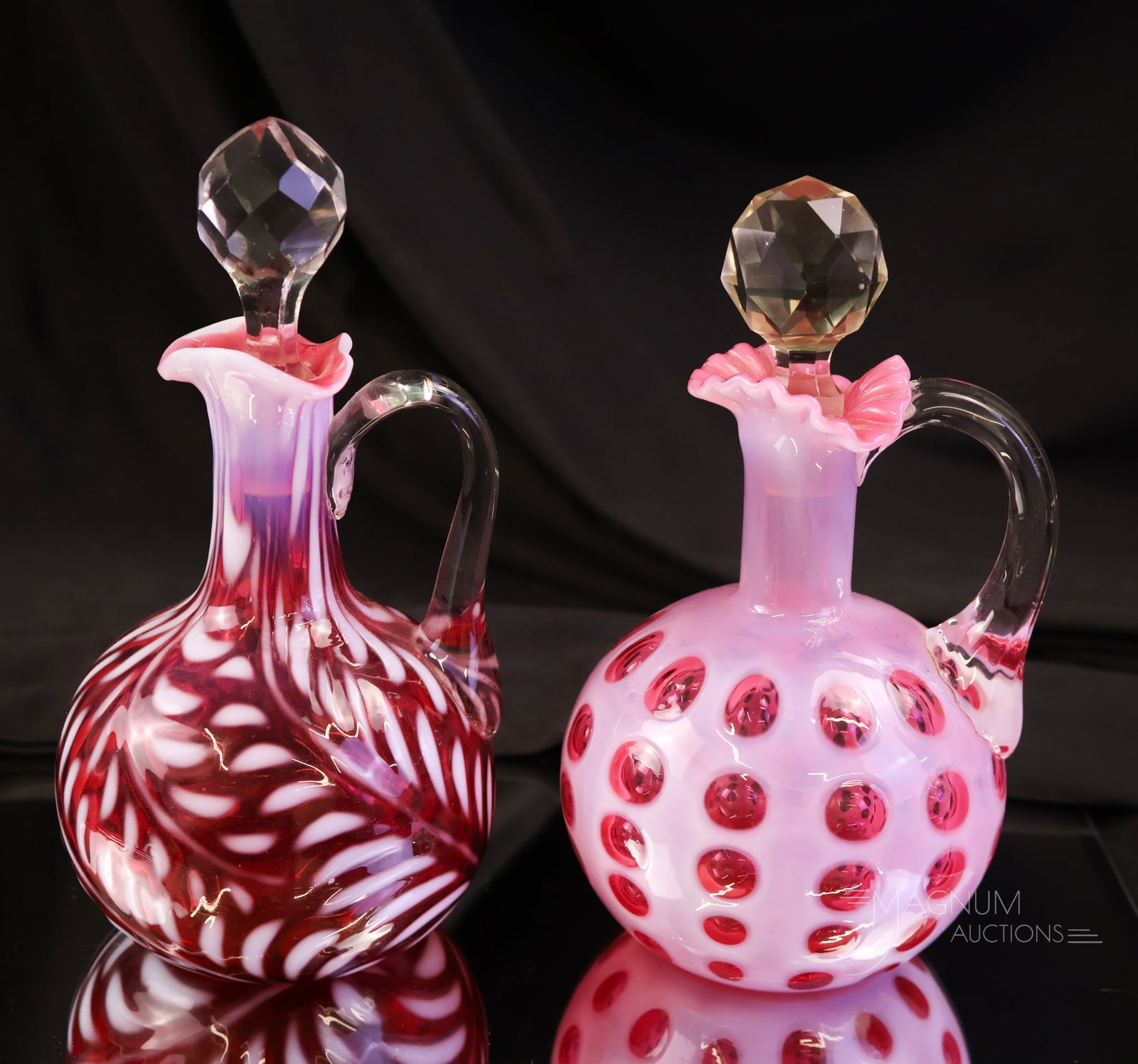 2 pc Lot Cranberry Opalescent Victorian Glass Cruets: Two beautiful examples of Victorian cranberry opalescent glass cruets. The first is in a Daisy & Fern pattern. The second is in a Polka Dot pattern. The tallest measures 6 1/2".