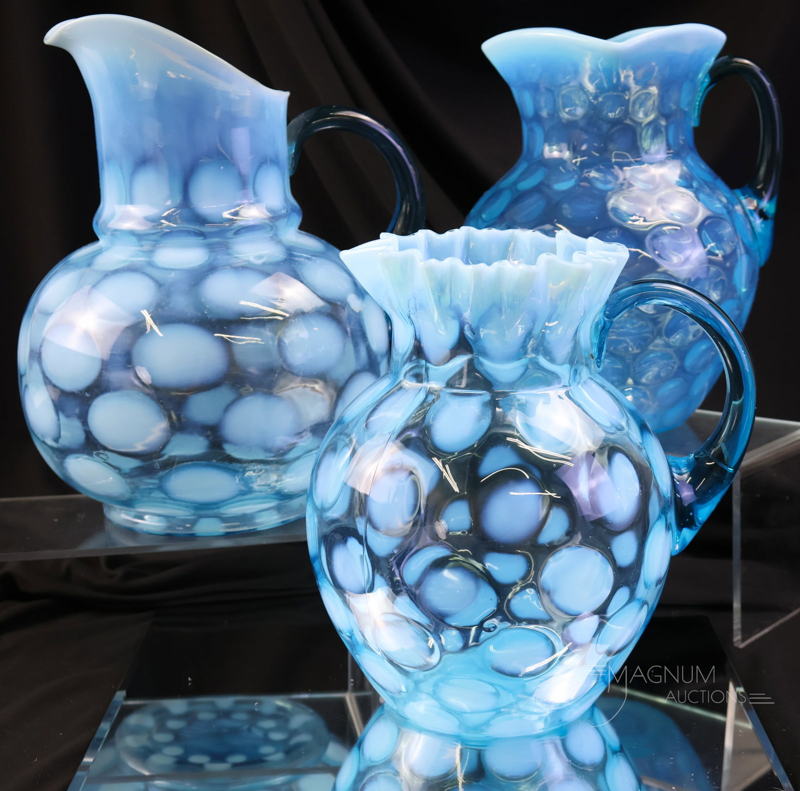 3 pc Lot Victorian Blue Opalescent Glass Water Pitcher: A three-piece lot of beautiful Victorian opalescent glass water pitchers in the Copinspot pattern. Three unique forms make up the mix. The tallest measures 10".