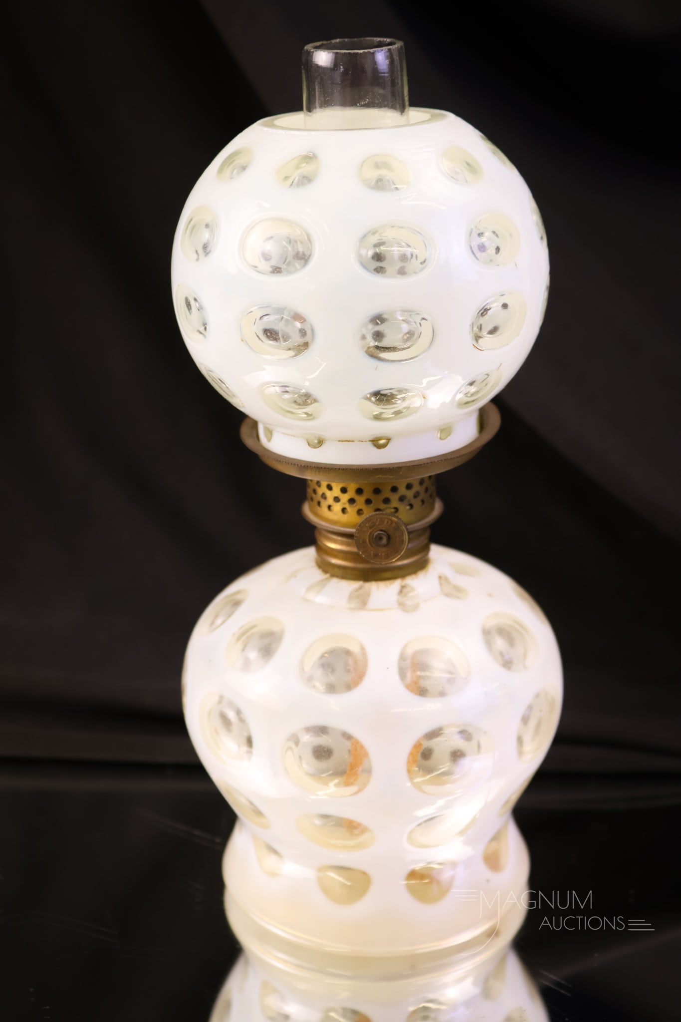 Victorian Polka Dot Opalescent Glass Miniature Oil Lamp: A charming little miniature Victorian oil lamp in the Polka Dot pattern. This lamp has beautiful white opal coloring and crisp clarity in the pattern. The lamp measures 7" tall and 3 1/2" wide.