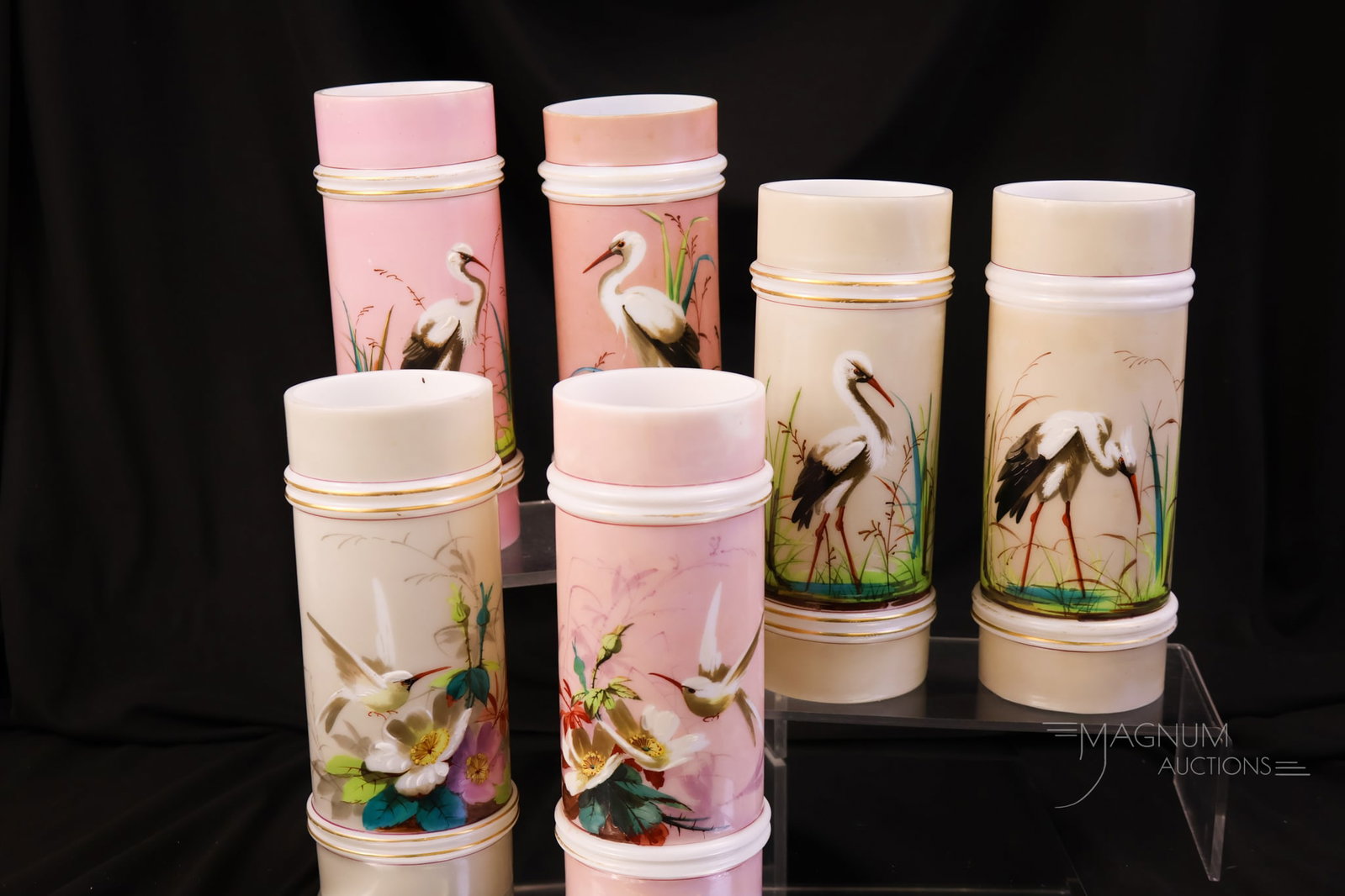 6 pc Lot Smith Bros. Victorian Glass Cylinder Vases: A collection-enhancing lot of six Victorian Smith Bros glass decorated cylinder vases. Four are decorated with Storks. Two are found with Hummingbirds. The tallest measures 8".