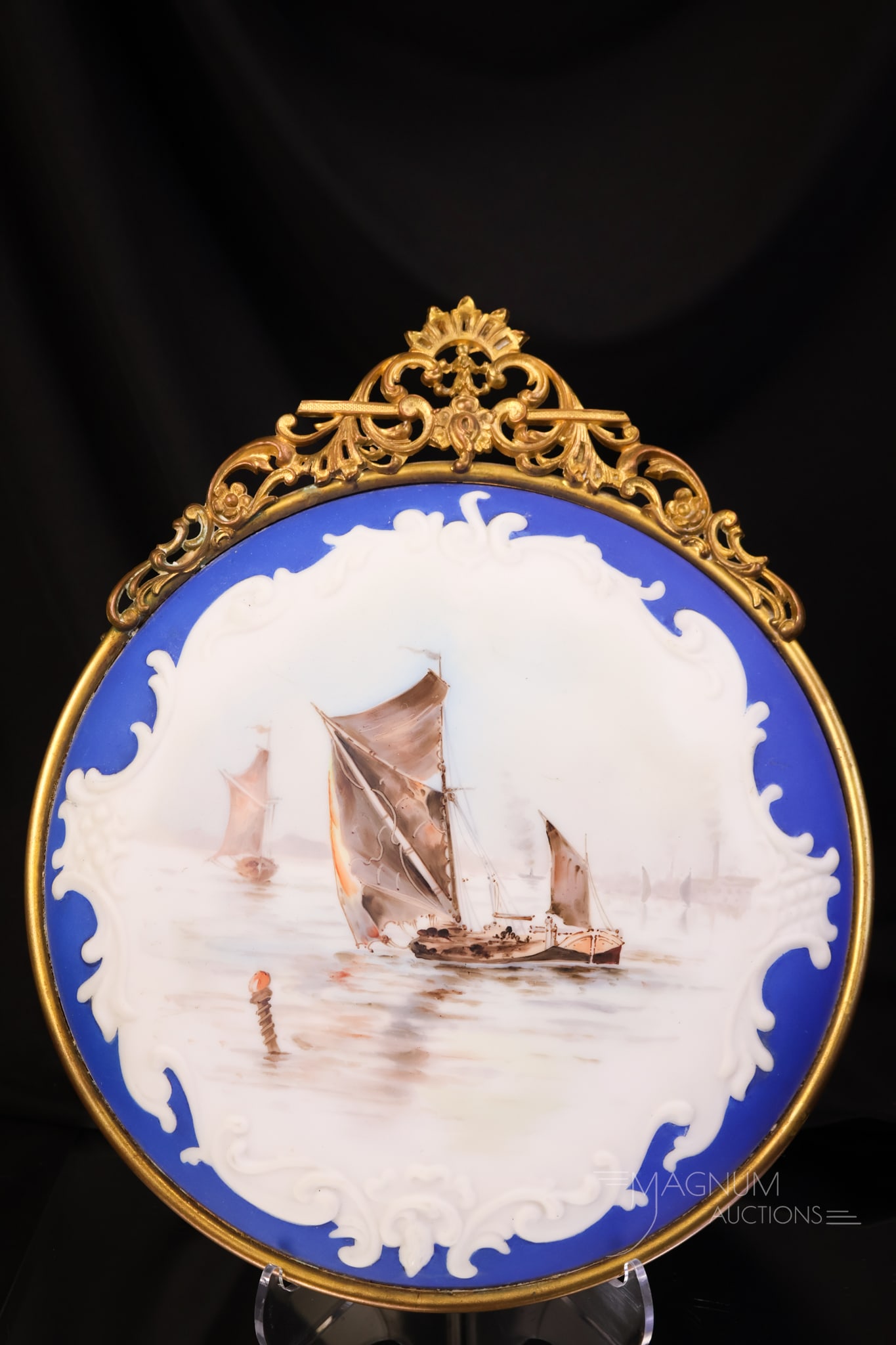 Wave Crest Victorian Glass Cobalt Sailboat Decorated Wall Plaque: A stunning Wave Crest Victorian decorated 10 1/4" wall plaque. This beautiful piece has a cobalt border and a sailboat scene. The plaque features the original frame and backing. The plaque measures 12