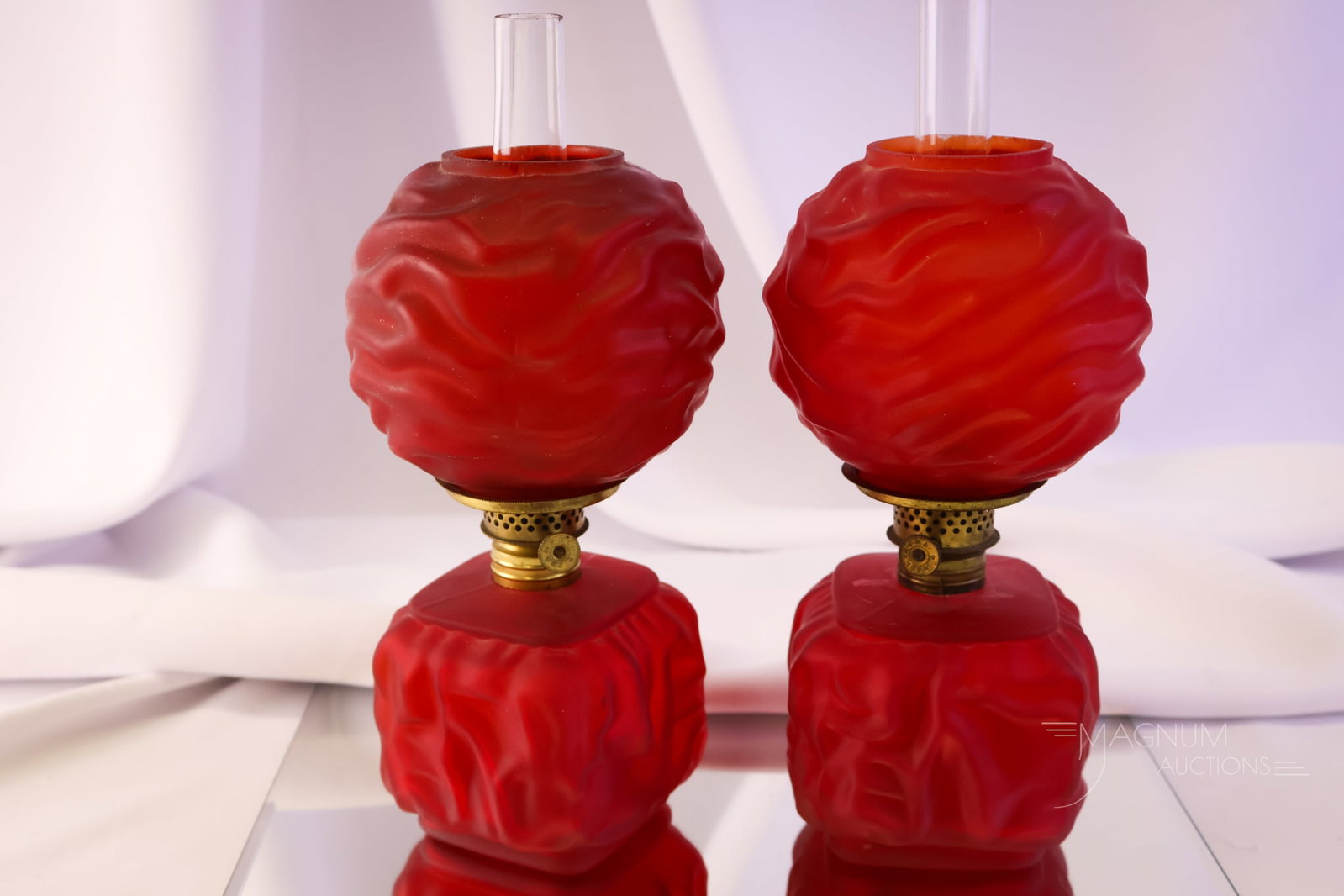 2 pc Lot Pigeon Blood Red Satin Glass Miniature Oil Lamps: Two wonderful and bright red satin Victorian miniature oil lamps. Often referred to as pigeon blood, these are highly collectible. The tallest measures 8". Both exhibit typical post-production flakes 
