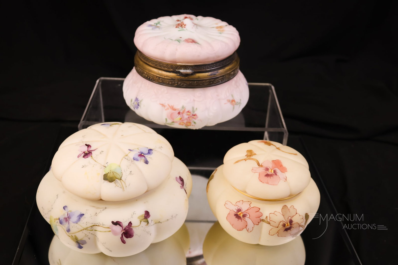 3 pc Lot Victorian Smith Bros. Pairpoint Dresser Jewelry Boxes: A three-piece lot of Victorian glass dresser jewelry boxes. Each is a lovely example of a bygone era. Two are signed Smith Bros. examples. One is marked Pairpoint. The tallest measures 3 1/4".