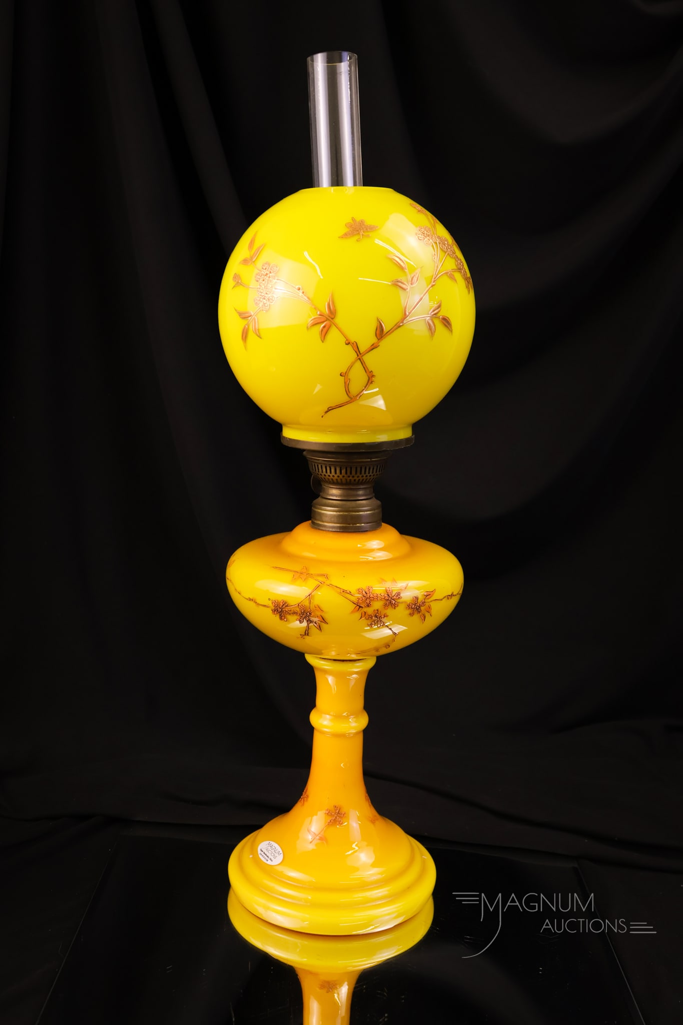 Victorian Yellow Cased Enameled Glass Junior Oil Lamp: A gorgeous deep yellow cased glass Victorian oil lamp. This lamp features a matching decoration on the shade to the font, to the base. Very nice! The lamp measures 16" tall and 5" wide.