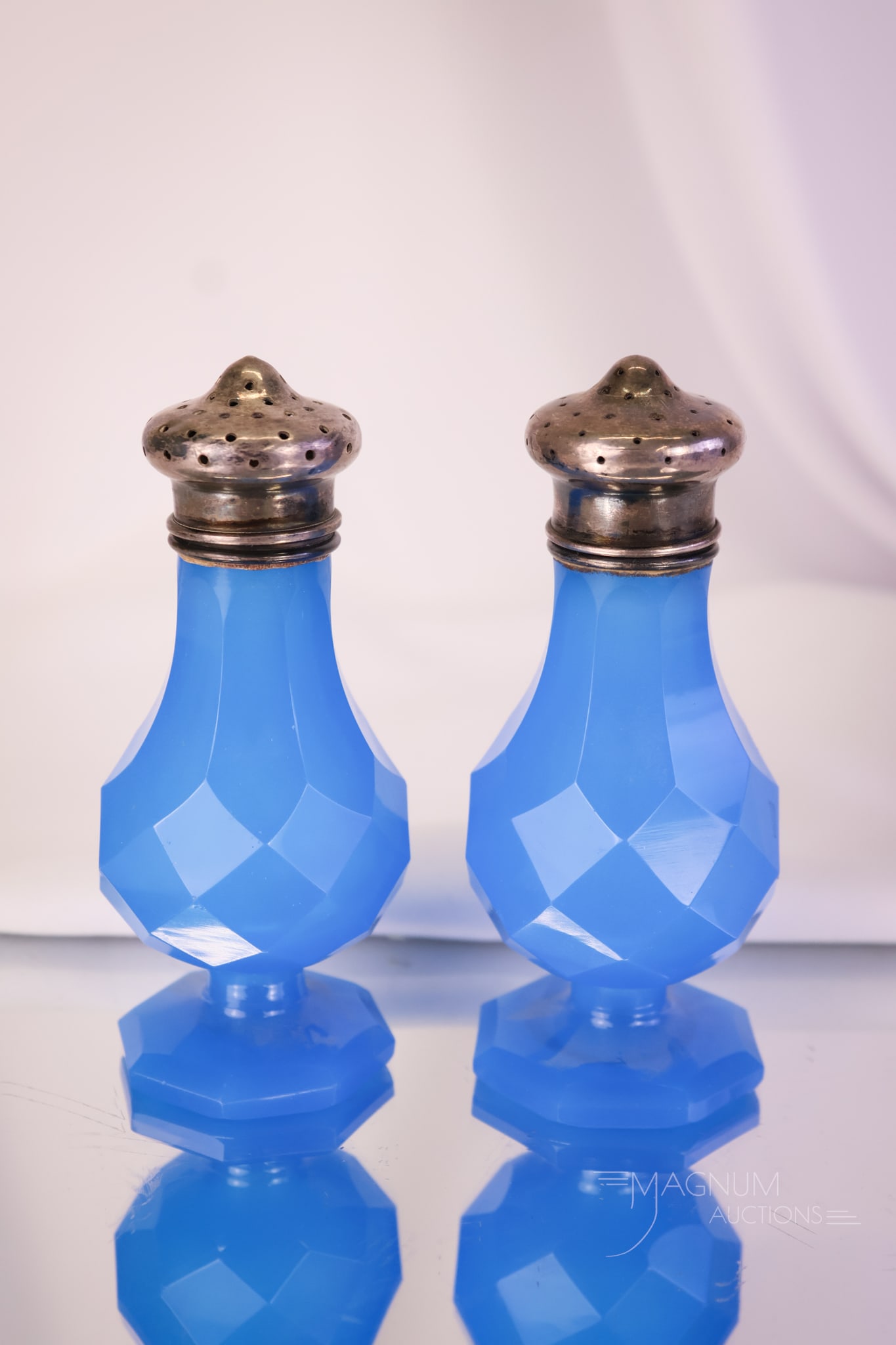 Pair Victorian Blue Opaline Georgian Cut Salt Shakers: A gorgeous pair of Georgian cut blue opaline Victorian glass salt shakers. Each measures 4" tall and 1 3/4" wide.