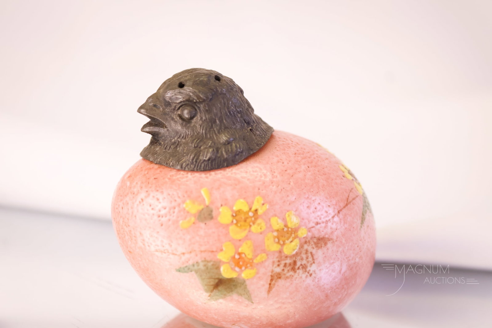 Mt. Washington Glass Victorian Chick Head Salt Shaker: A beautiful salmon colored Victorian Mt. Washington salt shaker. This charming find is decorated with yellow flowers. The shaker measures 2" tall.