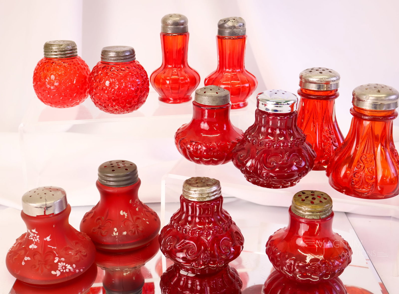 12 pc Lot Victorian Consolidated & Lancaster Pigeon Blood Glass Salt Shakers: A dozen Victorian pigeon blood Victorian salt shakers in this lot. Makers include Consolidated and Lancaster Glass. The tallest measures 3 1/4".