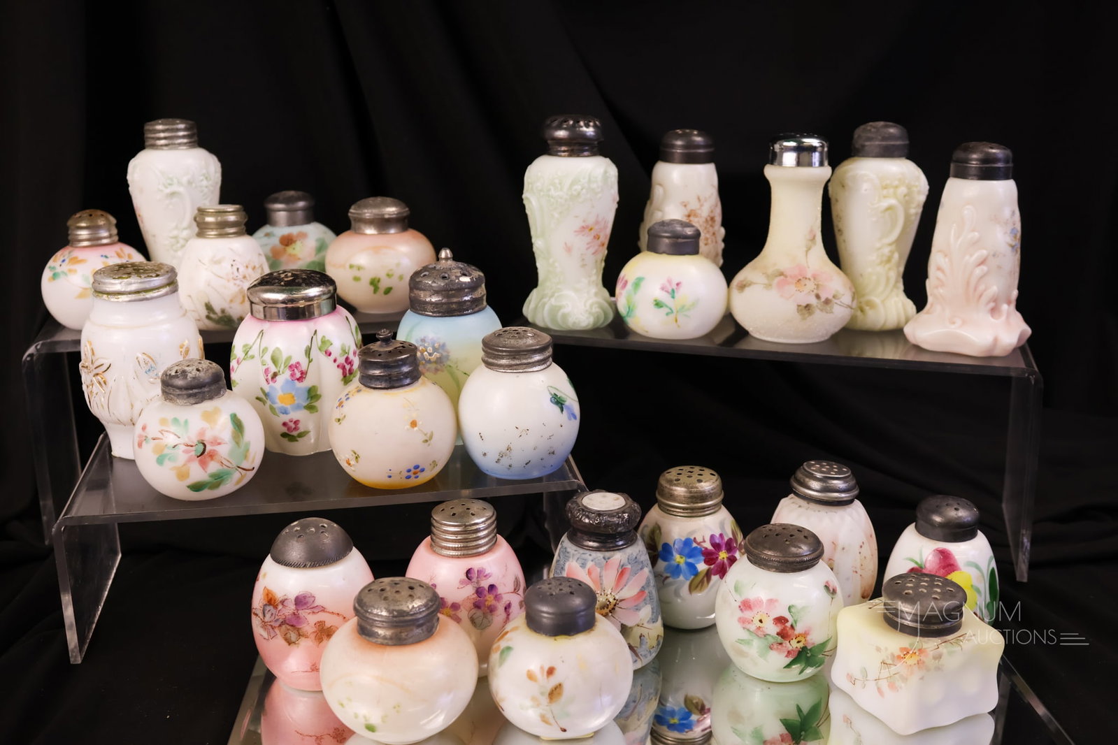 27 pc Lot Wave Crest Victorian Glass Salt Shakers Kelva & More: A generous offering of twenty-seven Victorian Wave Crest glass salt shakers. There are three pairs in the mix. The lot includes a blue Kelva and more. All are decorated. The tallest measures 4".