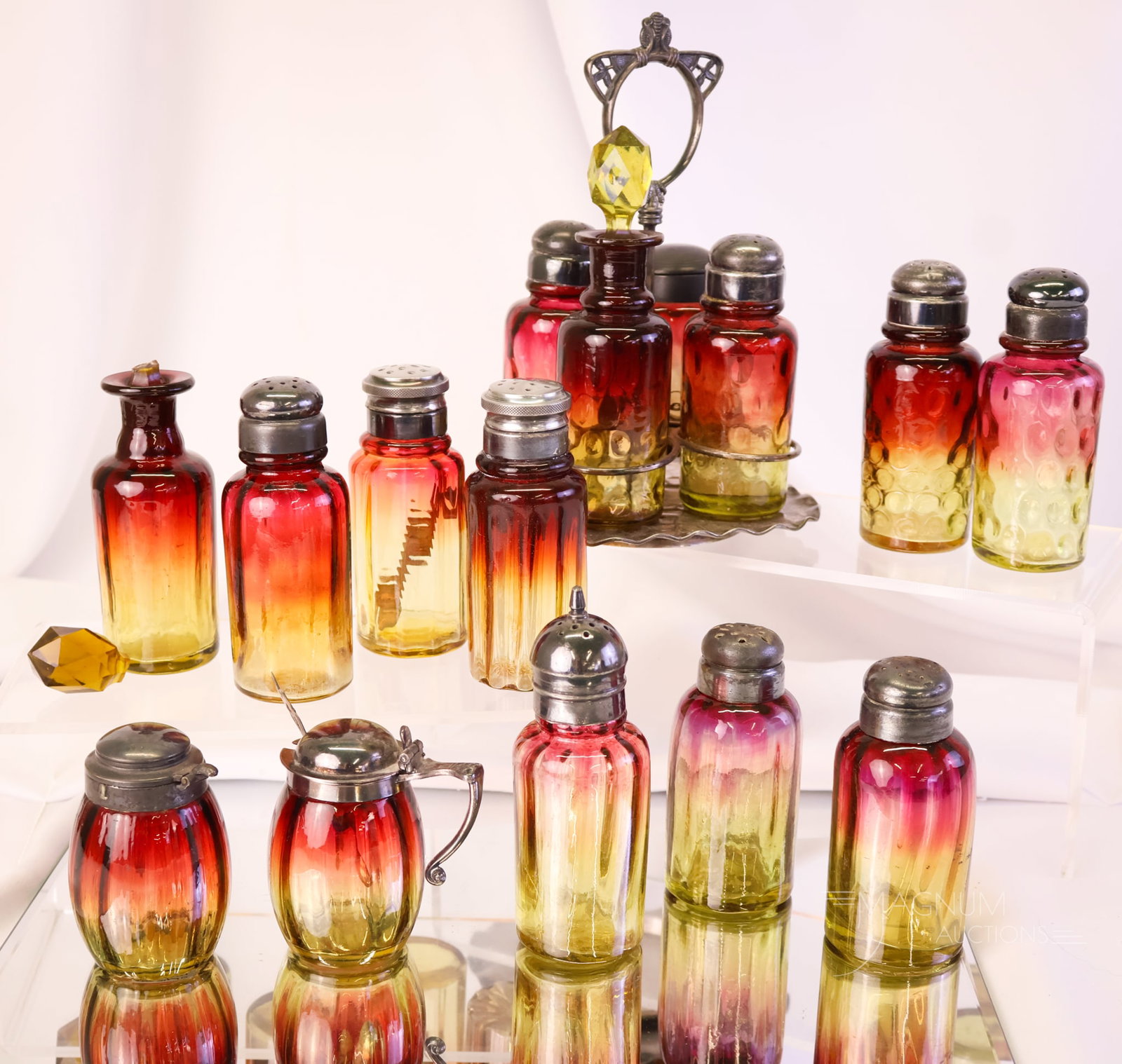 12 pc Lot Victorian Amberina Glass & Pairpoint Silverplate Shakers & More: A plentiful lot of Victorian amberina glass and Pairpoint silverplate for your bidding pleasure. This lot includes a four-piece condiment set. The mustard does not fit into the holder. There are six r