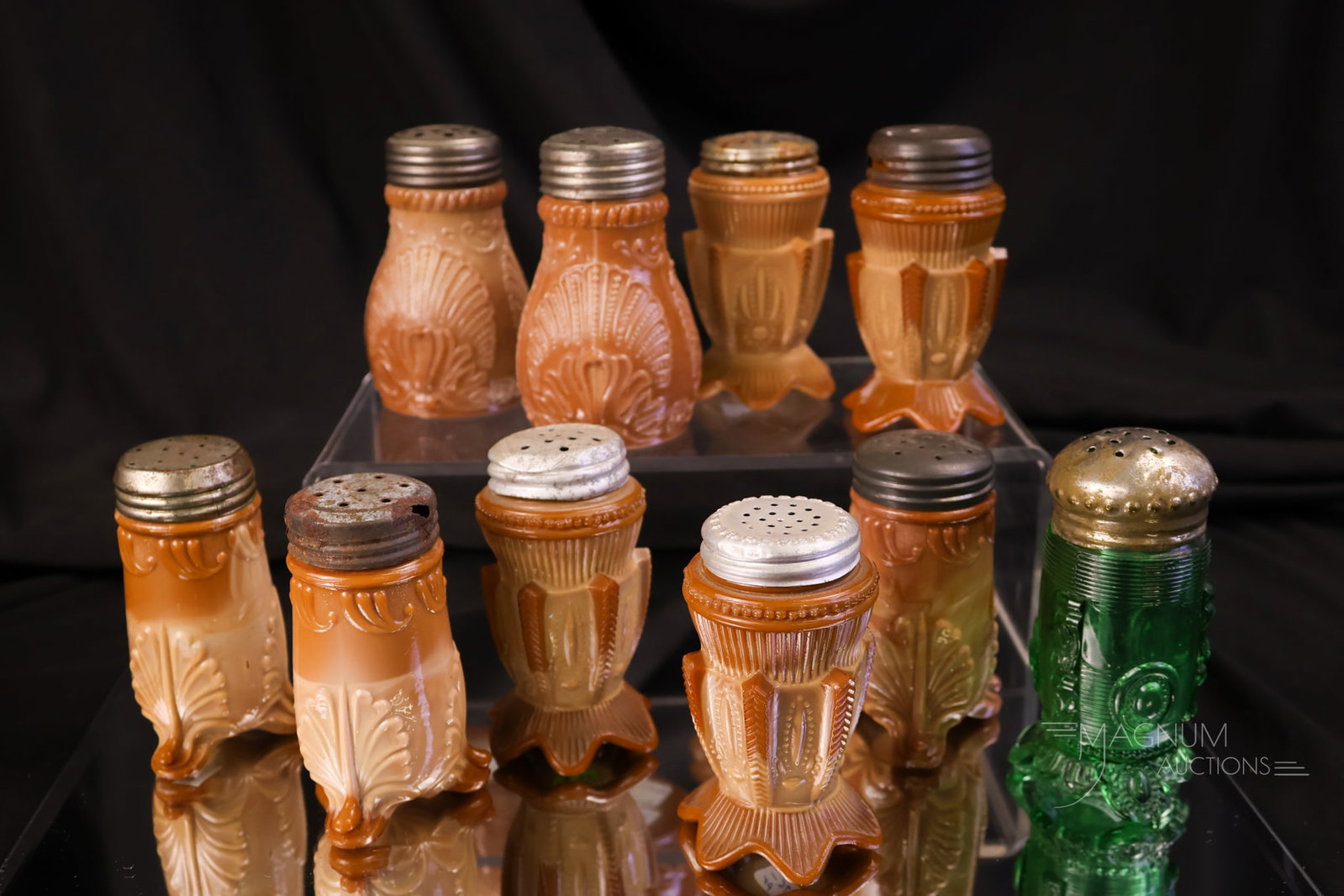10 pc Lot Victorian Greentown Glass Salt Shakers: Ten desirable finds in Victorian Greentown collectible glass. There are many chocolate shakers, including a pair of Cactus, a pair of Geneva shakers, and three Leaf Bracket shakers. There is also a te
