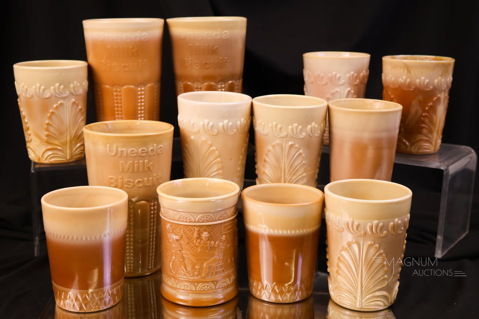 13 pc Lot Greentown Victorian Chocoalte Glass Tumblers: A variety of tumblers for your bidding pleasure. This lot includes thirteen Victorian chocolate glass tumblers. Various patterns, including Leaf Bracket, Uneeda Biscuit & more. The tallest measures 5 