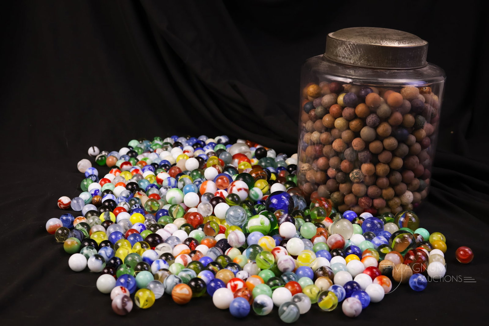 Lot of Antique & More Glass & Clay Marbles Uranium Included: A more than generous offering of clay and glass marbles. Most are antique. Some rare finds in the mix, including a couple of Uranium examples. The lot includes the jar. The tallest of the offering mea