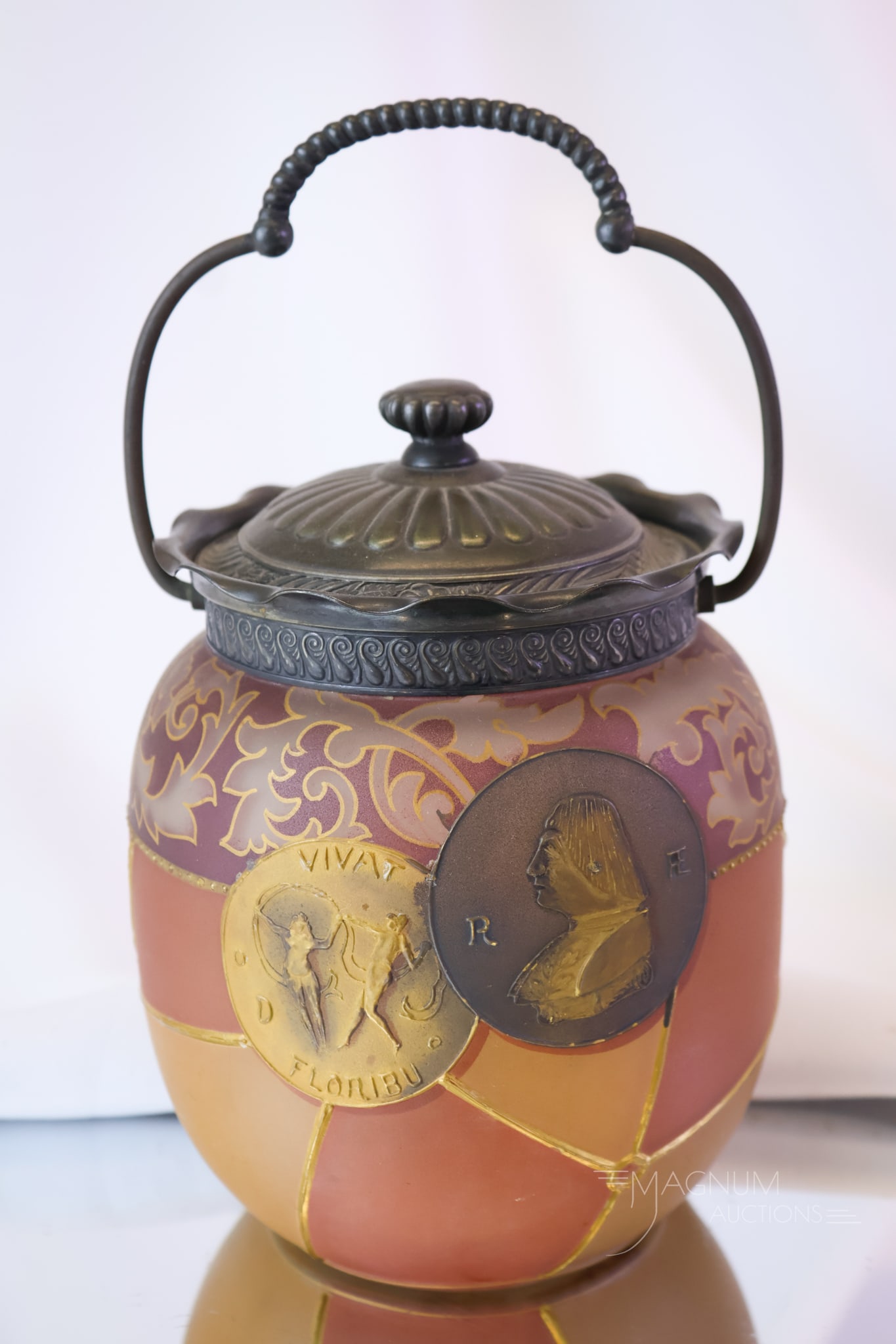 Mt. Washington Victorian Glass & Pairpoint Silverplate Royal Flemish Biscuit Jar: A fabulous find in Victorian Mt. Washington art glass and Pairpoint silverplate. This Royal Flemish line biscuit jar features a coin decoration against segmented panels.This piece measures 7" tall.