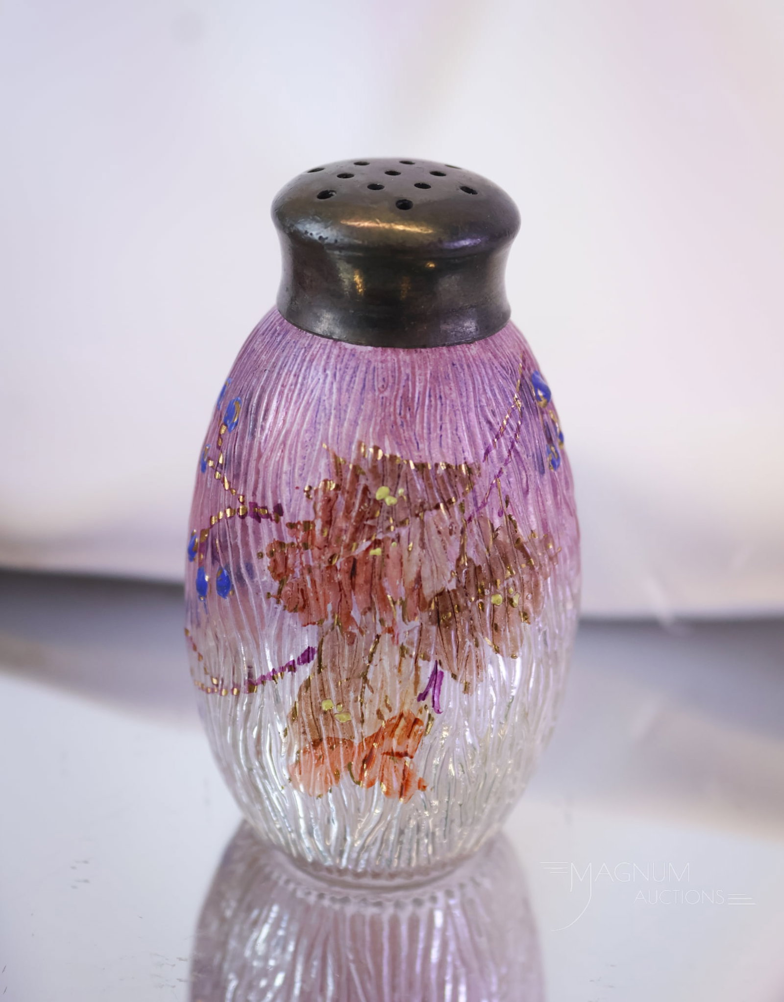 Scarce Mt. Washington Royal Flemish Victorian Glass Salt Shaker: A scarce find in a Mt. Washington glass salt shaker. This fine piece is seldom seen. It features a purple finish with leaf and blueberry decoration. The shaker measures 3" tall.