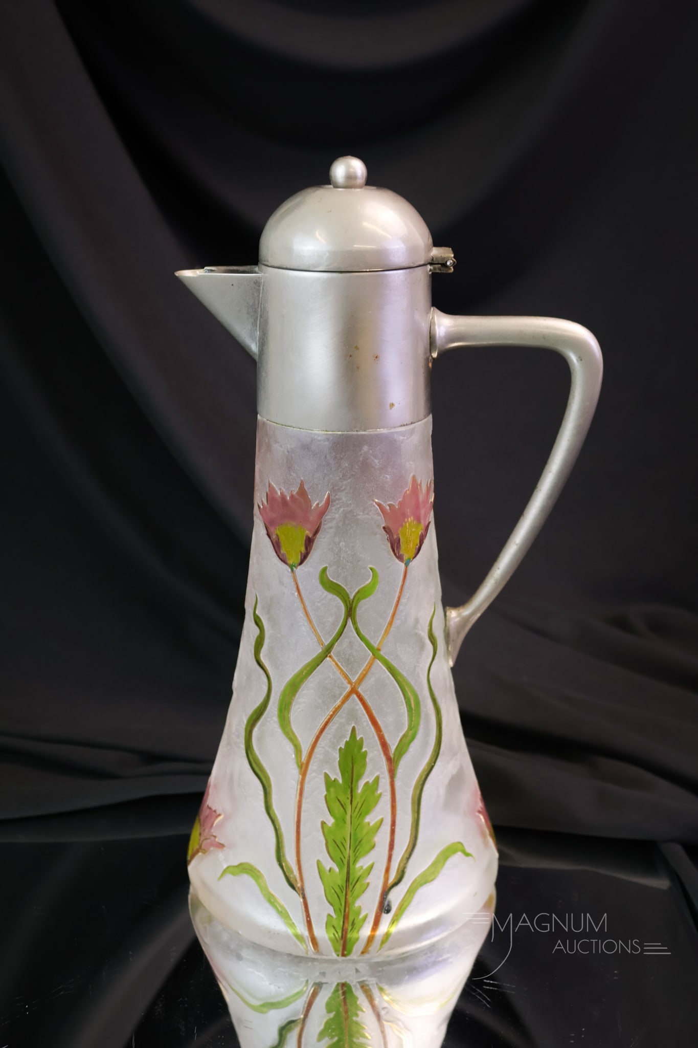 French Cameo Cut Claret Art Glass Claret: A beautiful claret decanter in French cameo glass. This piece has colorful flowers and foliage against a clear ground. The decanter measures 11" tall.