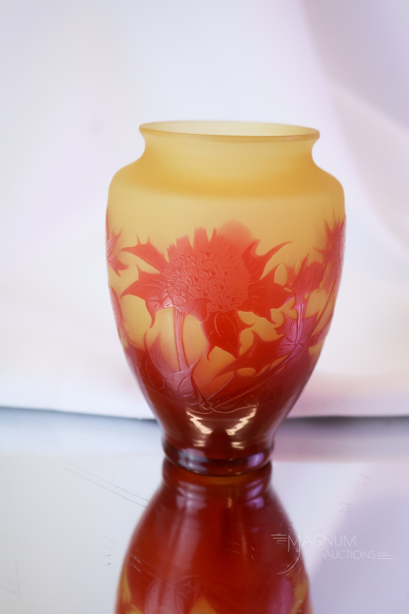 Signed D. Argental French Cameo Art Glass Cabinet Vase: A fine signed D. Argental French cameo art glass cabinet vase. This piece is in a light amber glass with red thistle flowers and foliage. The vase measures 3 1/2" tall and 2 1/2" wide.