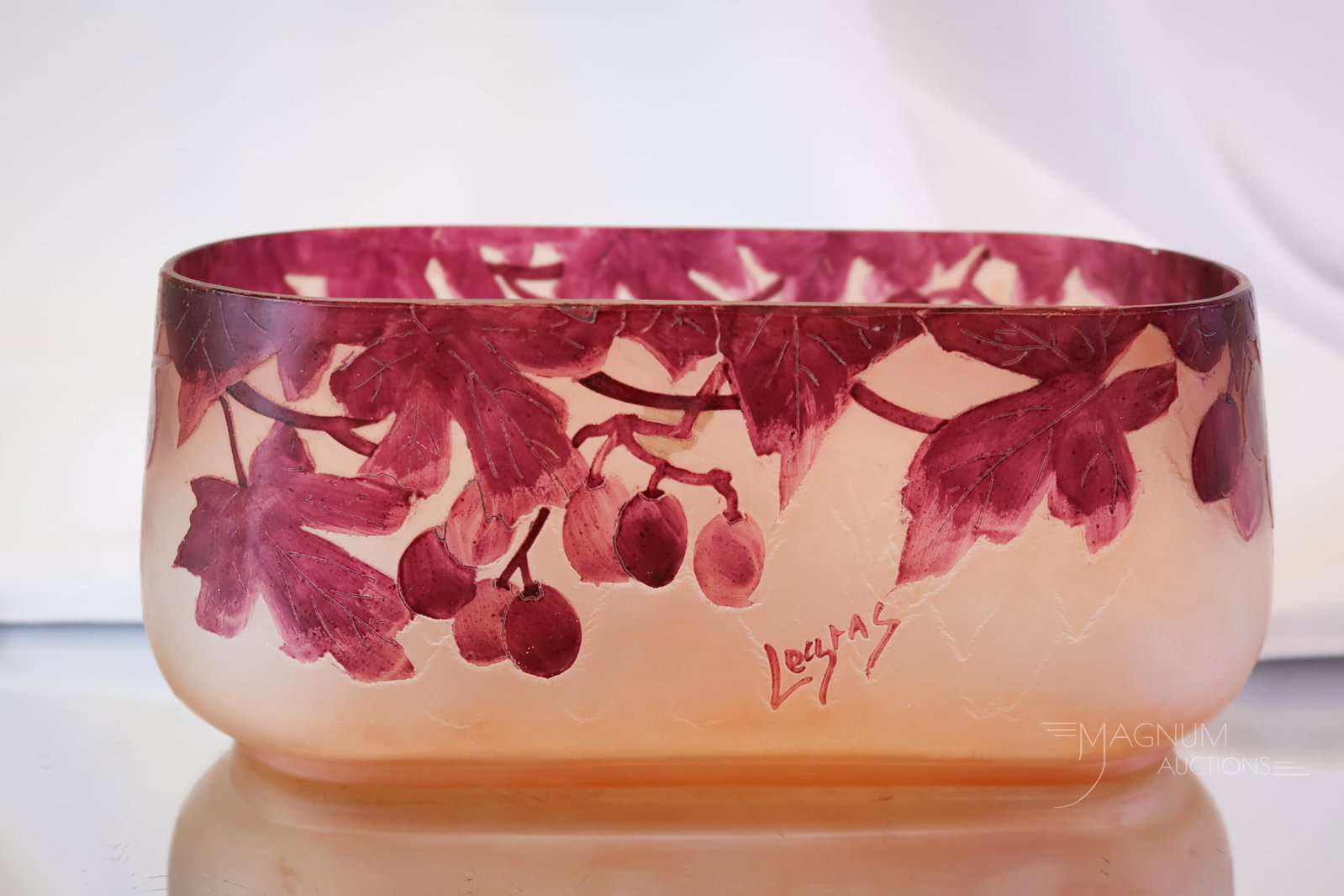 Signed Legras French Cameo Art Glass Vase: A lovely signed Legras cameo glass oval vase. This piece is decorated with grapes and foliage. The piece measures 3 1/2" tall and 7 1/4" wide.