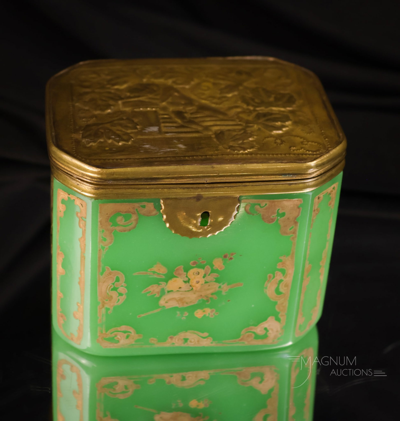 Jade Green Opaline Victorian Uranium Gilt Glass Jewelry Casket: A beautiful find for the Vasie collector. This jade green uranium-rich jewel box features an embossed metal lid and gilt trim. It glows brightly under black light. The casket measures 3 1/2" tall.