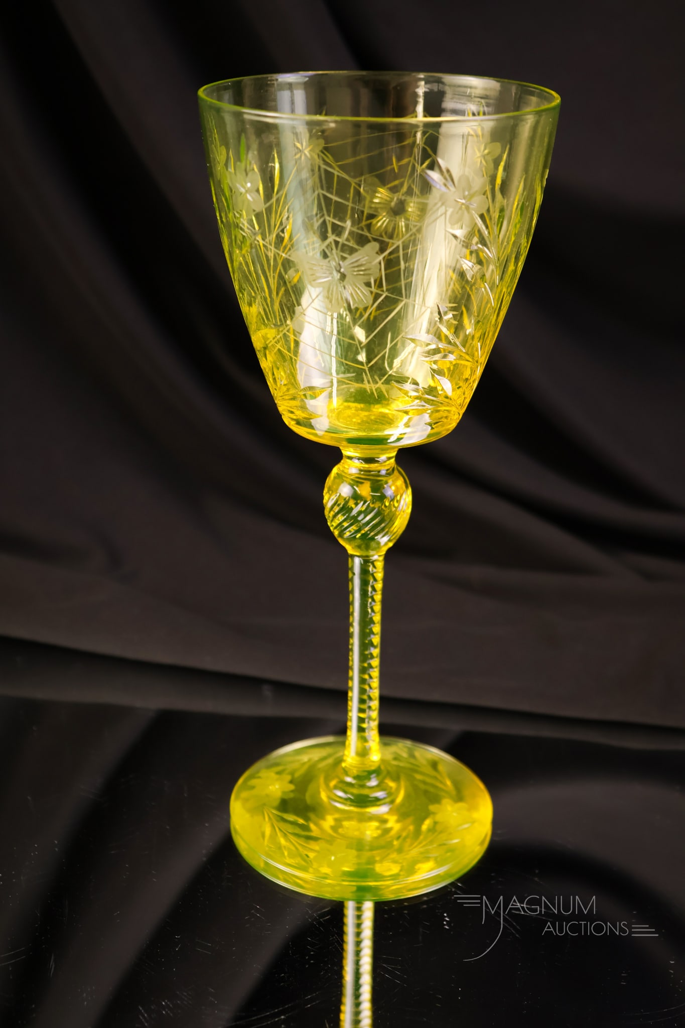 Pairpoint Canaria Vaseline Uranium Glass Colias Glass Water Goblet: A beautiful example of a Pairpoint Colias pattern water goblet. This piece is in uranium-rich vaseline glass. Pairpoint calls the color Canaria. The water goblet measures8" tall and 3 1/2" wide.