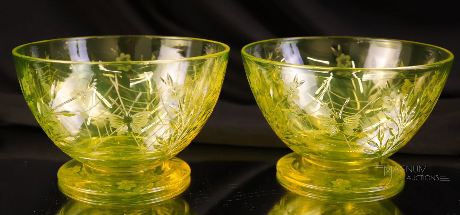 2 PC Lot Pairpoint Canaria Vaseline Uranium Colias Glass Finger Bowls: Two fine examples of Pairpoint Vaseline Uranium Canaria glass finger bowls in the Colias pattern. These shine brightly under black light. Each measures 2 1/2" tall and 4 1/4" wide.