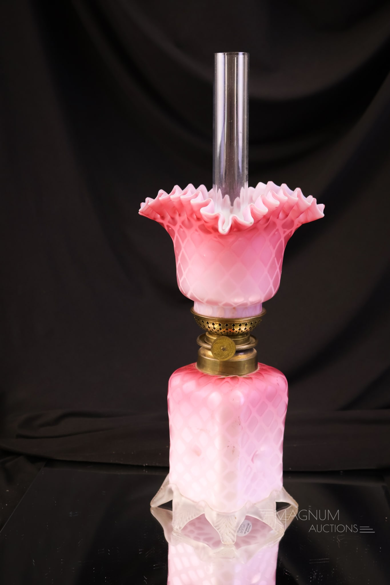 Victorian Mother of Pearl Diamond Quilted Satin Glass Miniature Oil Lamp: A beautiful and sought-after Victorian miniature oil lamp in pink satin diamond-quilted mother-of-pearl glass. This excellent example features applied glass feet on the base. The lamp measures10"
