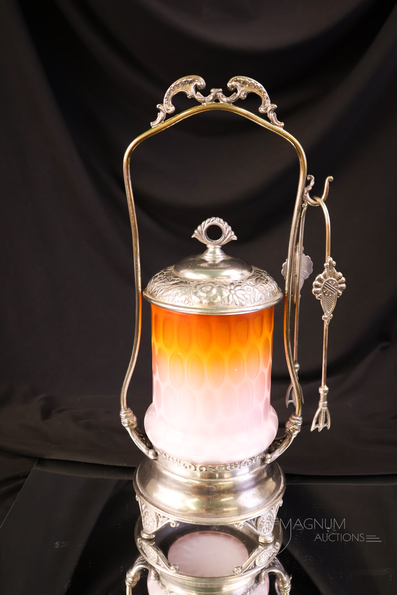 Simpson Hall Miller Victorian Silverplate Orange Satin Mother of Pearl Satin Glass Pickle Castor: A beautiful and rare Victorian Simpson Hall Miller signed silverplate pickle castor. This piece holds an orange Coinspot pattern mother-of-pearl satin glass pickle jar. The castor measures 12" tall.