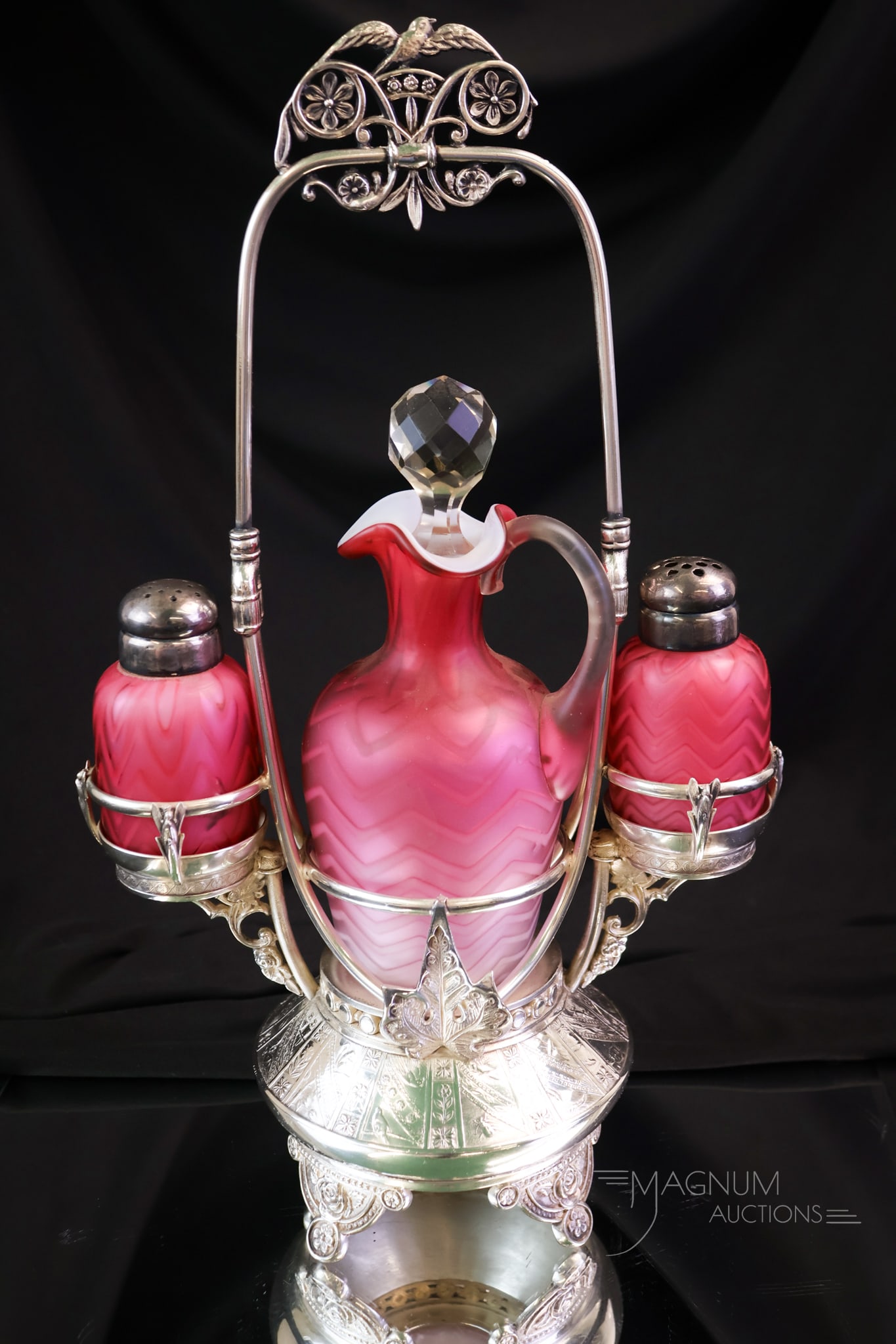 Aurora Silverplate Mother of Pearl Satin Glass Cruet Condiment Set: A wonderful find in a Victorian condiment castor. This piece has a signed Aurora silverplate castor frame. It holds a cruet and two shakers in a pink herringbone pattern mother-of-pearl glass. The set