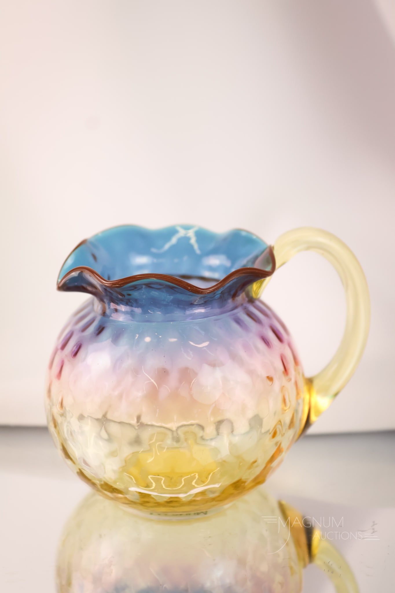 Webb Alexandrite Glass Victorian Honeycomb Creamer: A fabulous find in Webb Alexandrite glass. This is a rare creamer in a honeycomb pattern. This piece has all of the coloring you would wish to have in a fine piece of Alexandrite glass. The creamer me