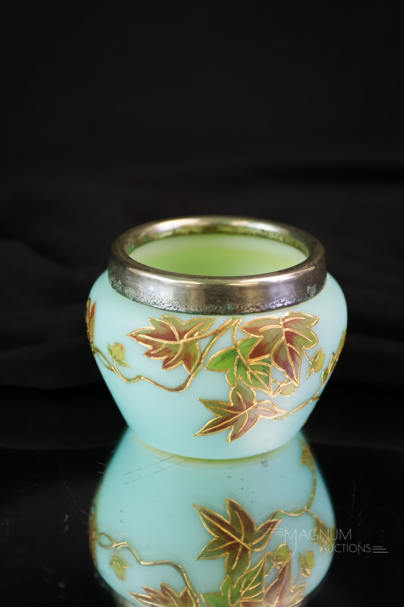 Blue Satin Uranium Glass Silver Victorian Open Salt: A beautiful blue satin uranium-rich open salt with an applied silver rim. This piece is gilt and enamel-decorated with foliage. It glows brightly under black light.