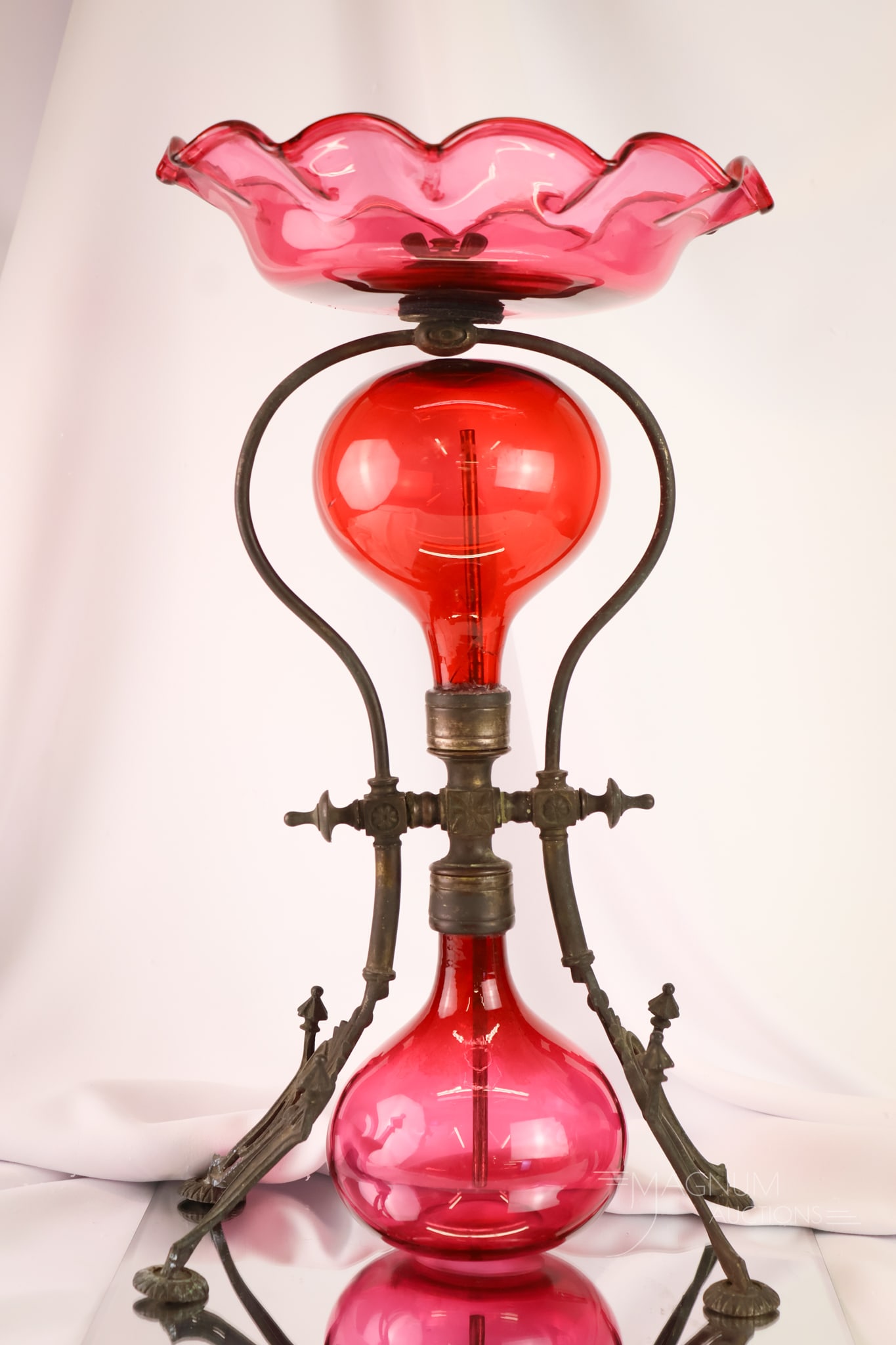 J. Defries & Sons, London Cranberry & Iron Victorian Perpetual Parlor Fountain: A signed J. Defries & Sons, London, cranberry glass perpetual parlor fountain. This piece features a cranberry glass and iron construction. The piece measures 18" tall and 10" wide. One globe
