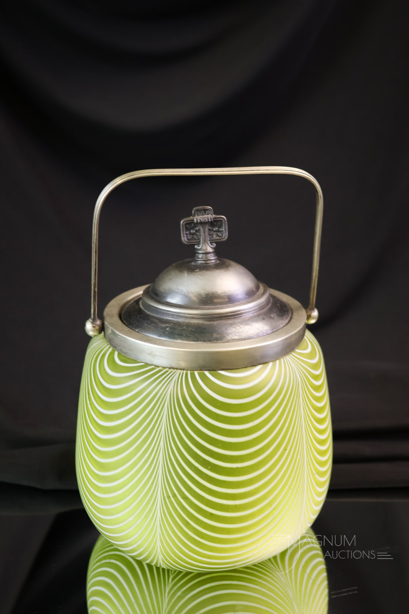Victorian Citron Nailsea Art Glass Biscuit Jar: An unusual find in Victorian Nailsea glass. This is a full-size biscuit jar in citron-colored Nailsea glass. This jar has a silverplate rim, bail, and lid. The jar measures 7 1/2" tall.